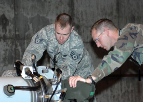 WHITEMAN AIR FORCE BASE, Mo., - Capt. Bobby Hershner, 509th Munitions Squadron Strategic Weapons Flight commander, and Staff Sgt. Heath York, 509th Maintenance Group Quality Assurance, inspect a rotary launcher assembly in the active stockpile.  (U.S. Air Force photo/ Staff Sgt. Charles Larkin)