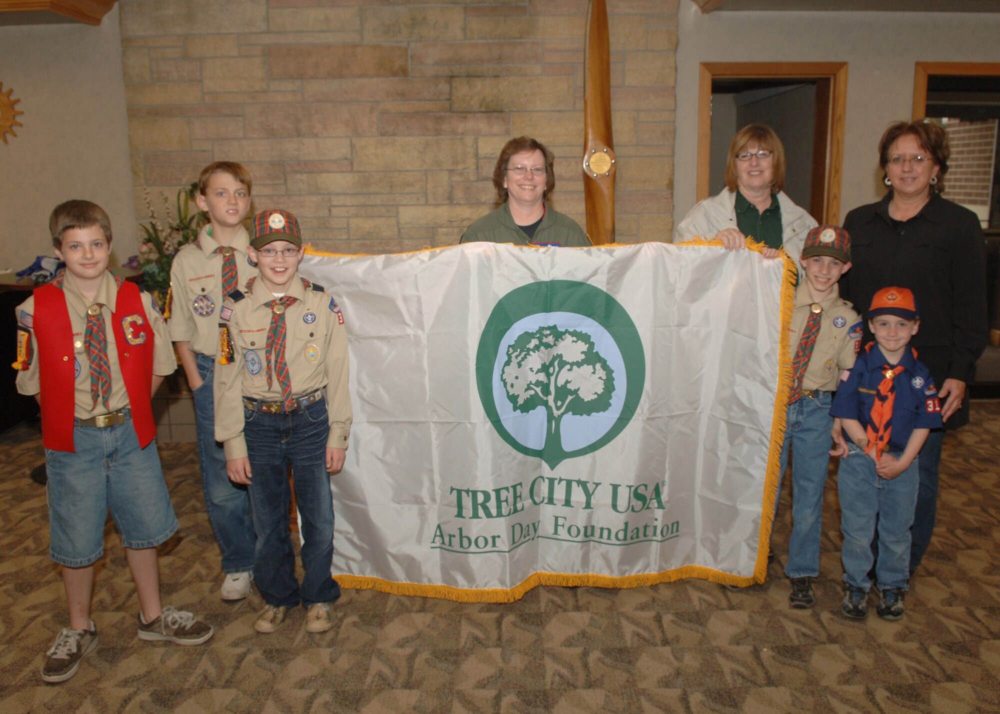 Col. Diane Hull, 319th Air Refueling Wing Commander (center) receives a banner from the Arbor Day Foundation with Cub Scouts from Pack 319 here June 3, 2008. The base has participated in the Tree City USA initiative for the past 15 years and has planted several hundred trees in as many years.  (U.S. Air Force photo/Senior Airman Chad Kellum)
