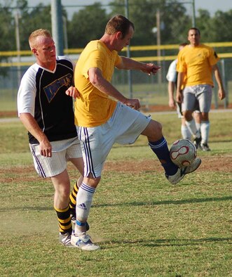 Scott Franz, 965th Airborne Air Control Squadron fullback, tries to keep the ball from 963rd AACS defender Jeremiah Miller during the intramural soccer championship game June 3.  The 963rd AACS claimed the title after the 5-0 shut out.  (Air Force photo by John E. Banks)