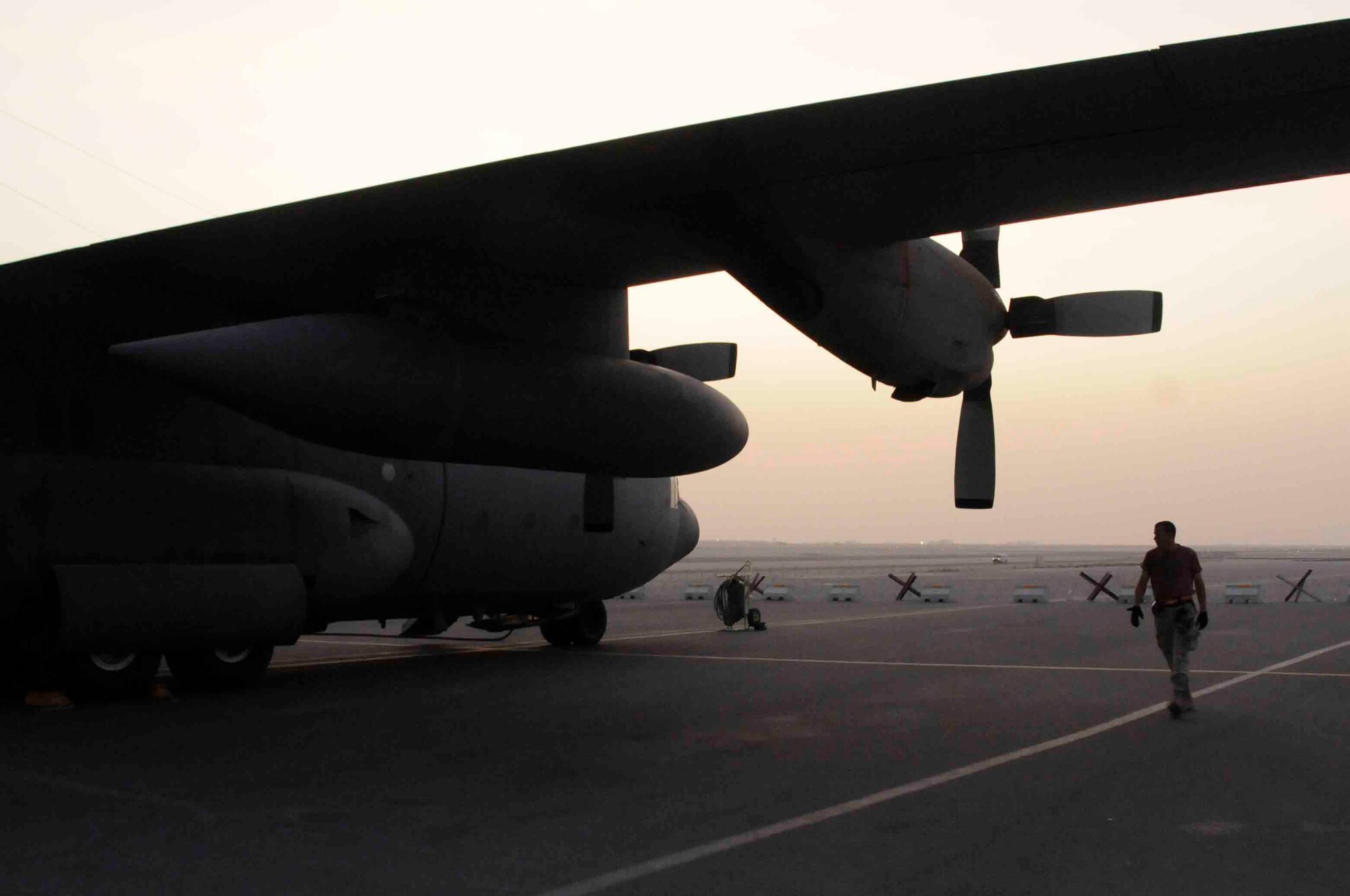 Southwest Asia - Tech Sgt. Eric D. Moseman, 379th Expeditionary Airlift Maintenance Squadron, performs post flight checks on the outside structure of a C-130 Hercules after its return from a mission throughout Iraq at a Southwest Asia air base June 11.  Sergeant Moseman and his team will completely inspect, refuel, and prepare the aircraft for its next mission. He is deployed from Niagara Falls Air Reserve Station, N.Y. (U.S. Air Force photos/Tech. Sgt. Johnny Saldivar)