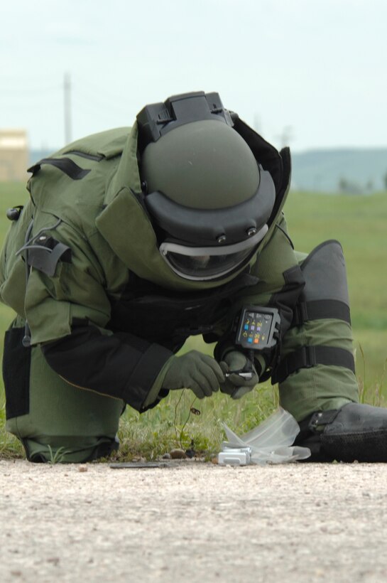 Tech. Sgt. Jason Wells, 28th Civil Engineer Squadron explosive ordnance device technician, disconnects the battery from the remote detonator of a controlled improvised explosive device here June 11. Sergeant Wells participated in a training exercise involving IED disposal. (U.S. Air Force photo/Airman Matthew Flynn) 

