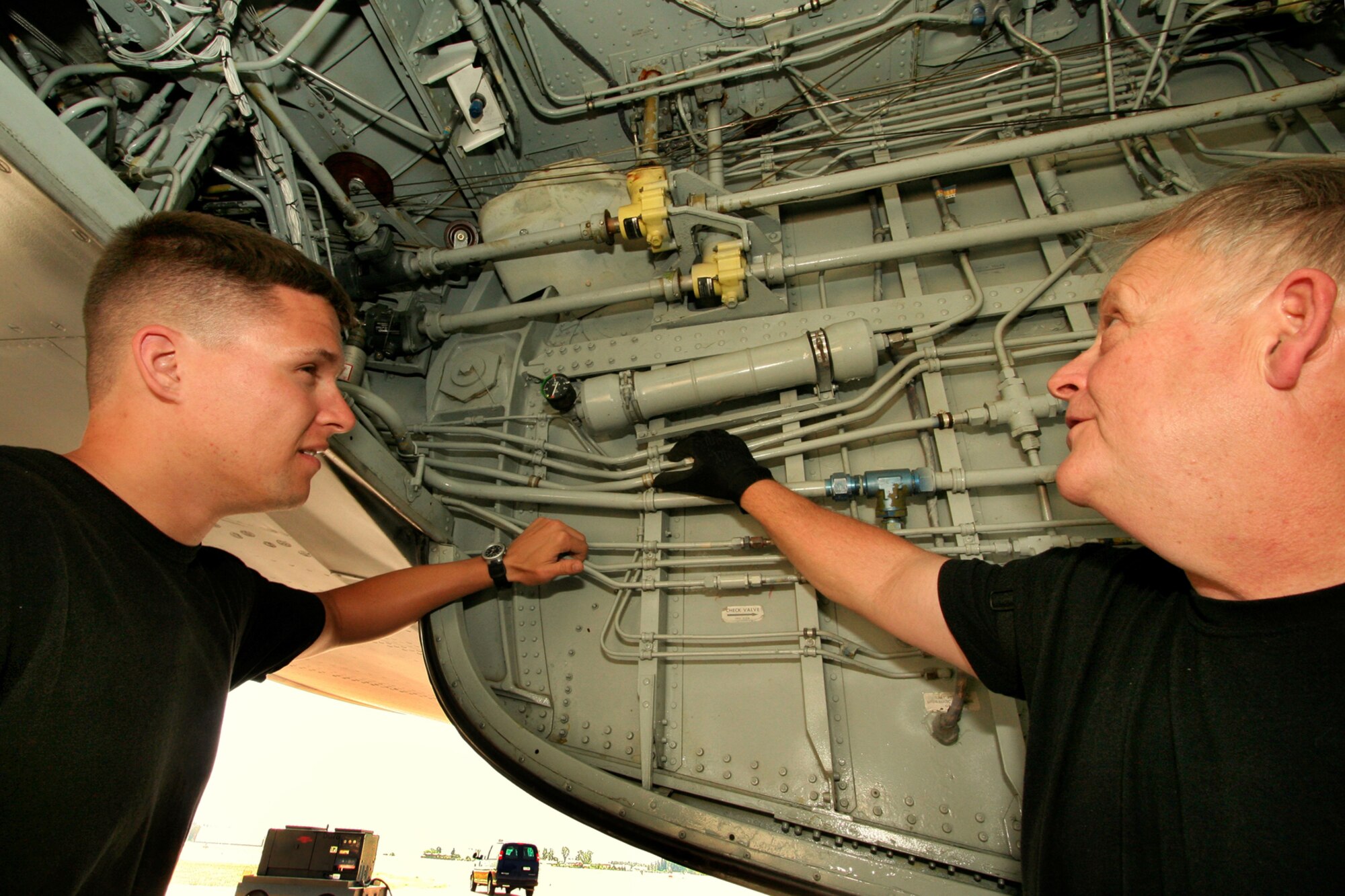 INCIRLIK AIR BASE, TURKEY -- Master Sgt. John Bond, right, a KC-135R Stratotanker mechanic, shows Senior Airman Adam Dyer, a KC-135R crew chief, the brake accumulator and other items on the Stratotanker prior to the aircrew arriving for a mission. The deployment to Incirlik is a valuable training opportunity for many younger members of the unit. (U.S. Air Force photo/Tech. Sgt. Patrick Kuminecz)