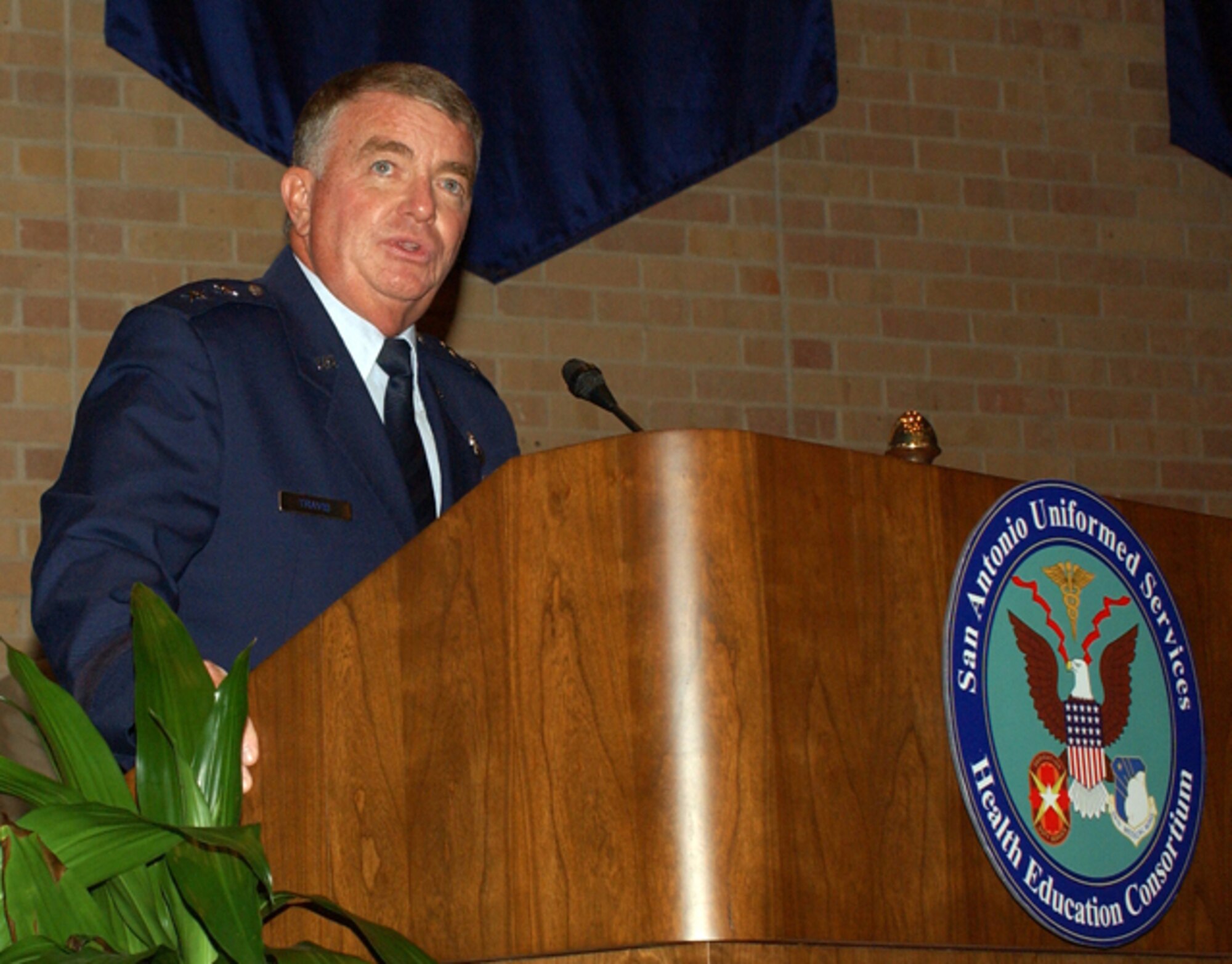 59th Medical Wing Commander Maj. Gen. (Dr.) Thomas Travis speaks to graduates at the San Antonio Uniformed Services Health Education Consortium awards and graduation ceremony June 6 in the University of Texas Health Science Center at San Antonio Auditorium. The ceremony honored 241 physicians and allied health care providers. (U.S. Air Force photo/Alan Boedeker) 