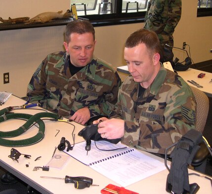 Master Sgt. Mark Adams, 648th Aeronautical Equipment Systems Squadron, and Tech. Sgt. Bobby Pickel, 305th Operations Support Squadron, assemble a Quick Don Mask prototype, designed to provide an advanced protective integration of the eyes and nose, for the Air Mobility Command Test and Evaluation Squadron recently at McGuire AFB, N.J.  (U.S. Air Force photo/Senior Master Sgt. Cliffton Herndon)