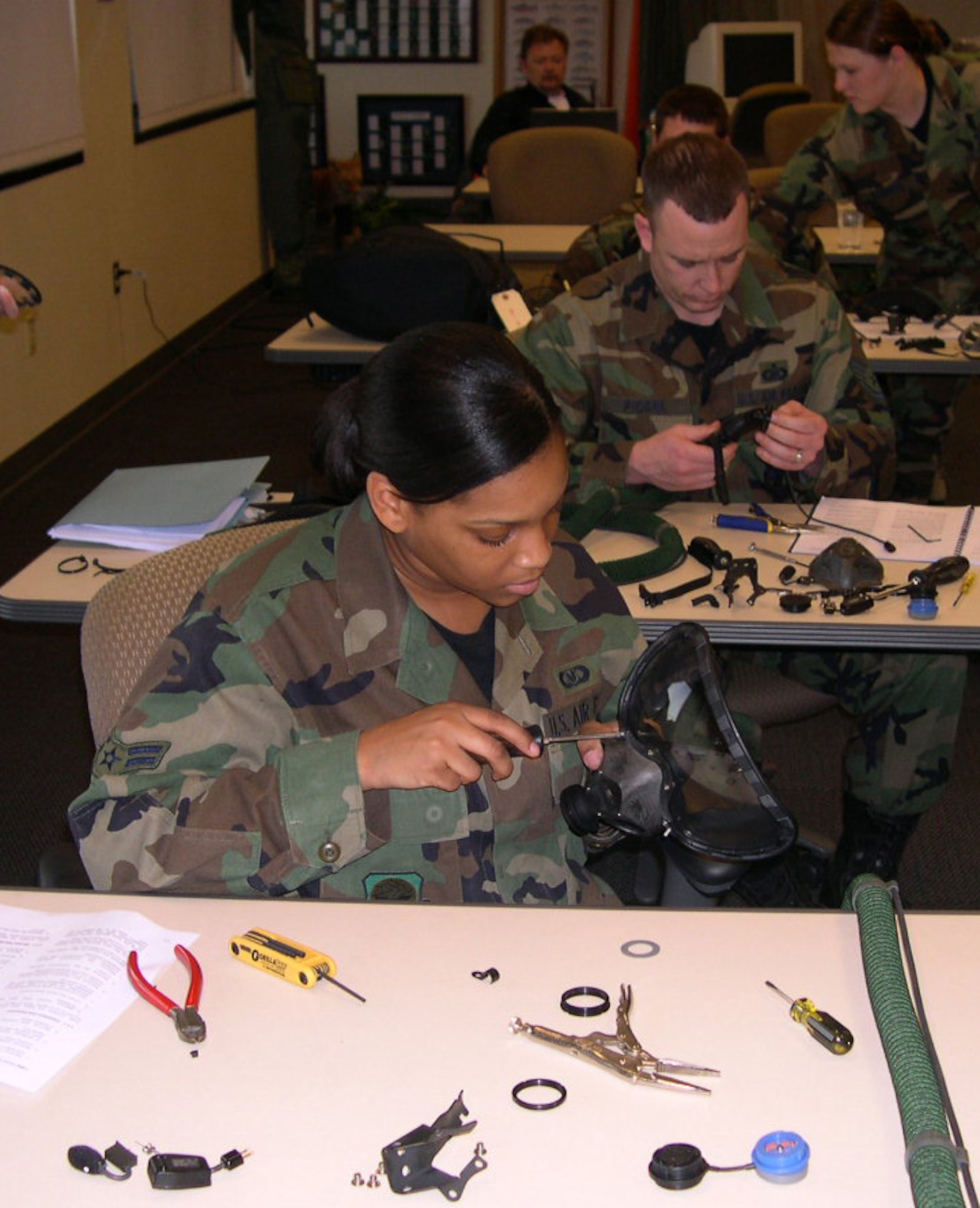 Airman 1st Class Latoya Singleton, 305th Operations Support Squadron, assembles a Quick Don Mask prototype, designed to provide an advanced protective integration of the eyes and nose, for the Air Mobility Command Test and Evaluation Squadron recently at McGuire AFB, N.J.  (U.S. Air Force photo/Senior Master Sgt. Cliffton Herndon)