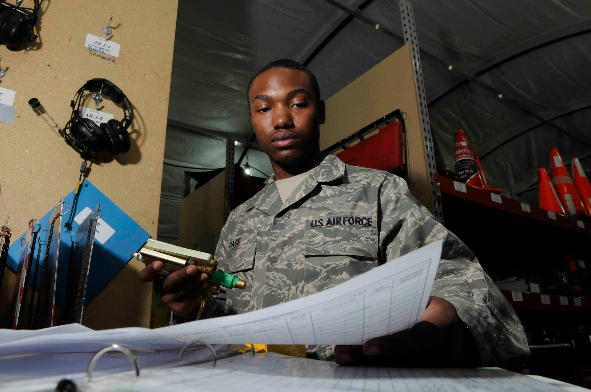 SOUTHWEST ASIA - Airman 1st Class Timothy Pace, 746th Aircraft Maintenance Unit, inspects and ensures paperwork matches item number at a Southwest Asia air base June 11.  Airman Pace tracks 1,308 tools and maintenance equipment for U.S. and coalition C-130 maintenance crews. He is originally from Detroit, Mich. and deployed from Little Rock Air Force Base, Ark. (U.S. Air Force photos/Tech. Sgt. Johnny Saldivar)