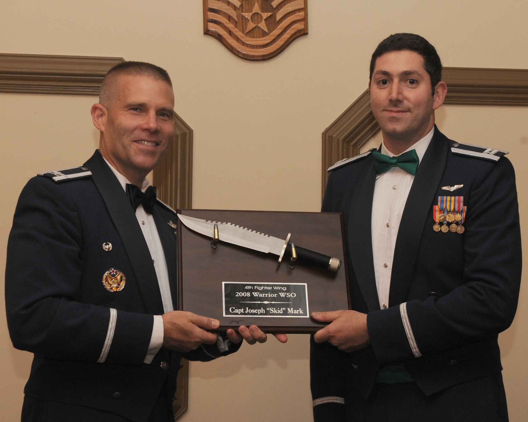 4th Fighter Wing commander Colonel Steve Kwast, presents Captain Joseph Mark with an award for warrior weapons systems officer. Capt Mark is the wing's warrior wso for 2007.