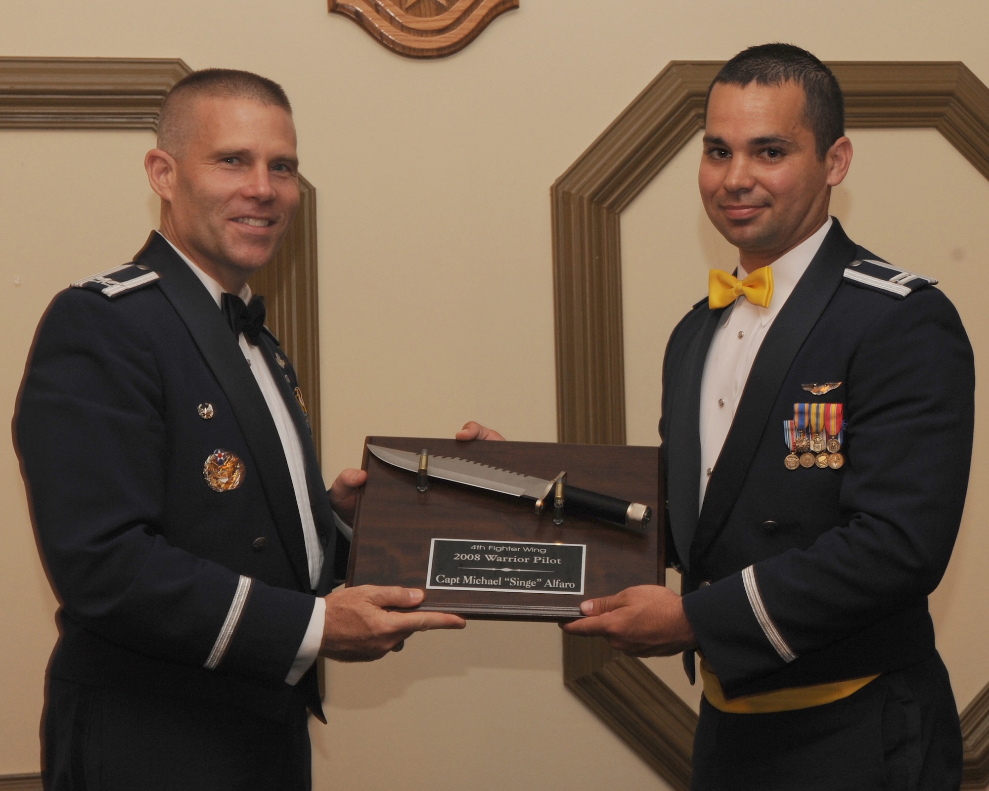 4th Fighter Wing commander Colonel Steve Kwast, presents Captain Michael Alfaro with an award for warrior pilot. Capt Mark is the wing's warrior pilot for 2007.
