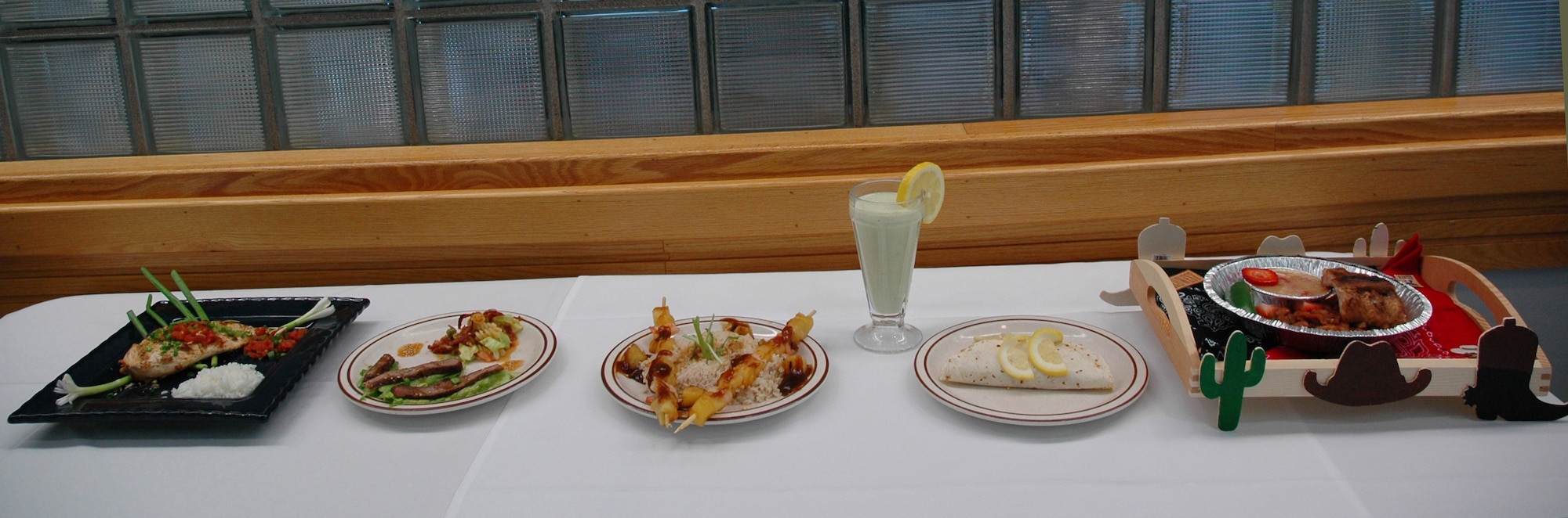 Five teams competed and five dishes were prepared at this quarter's Warrior Chef competion June 10 at the Elkhorn Diner. Airman 1st Class Joey Klein and Staff Sgt. Jeremy Smith, 12th Missile Squadron, took first place with their Asian barbecue shrimp and coconut rice (center). The other dishes pictured from left to right include Monterey barbecued chicken, sesame barbecued grilled beef, barbecued shrimp fajitas and barbecued baby back ribs. (U.S. Air Force photo/Airman 1st Class Emerald Ralston)