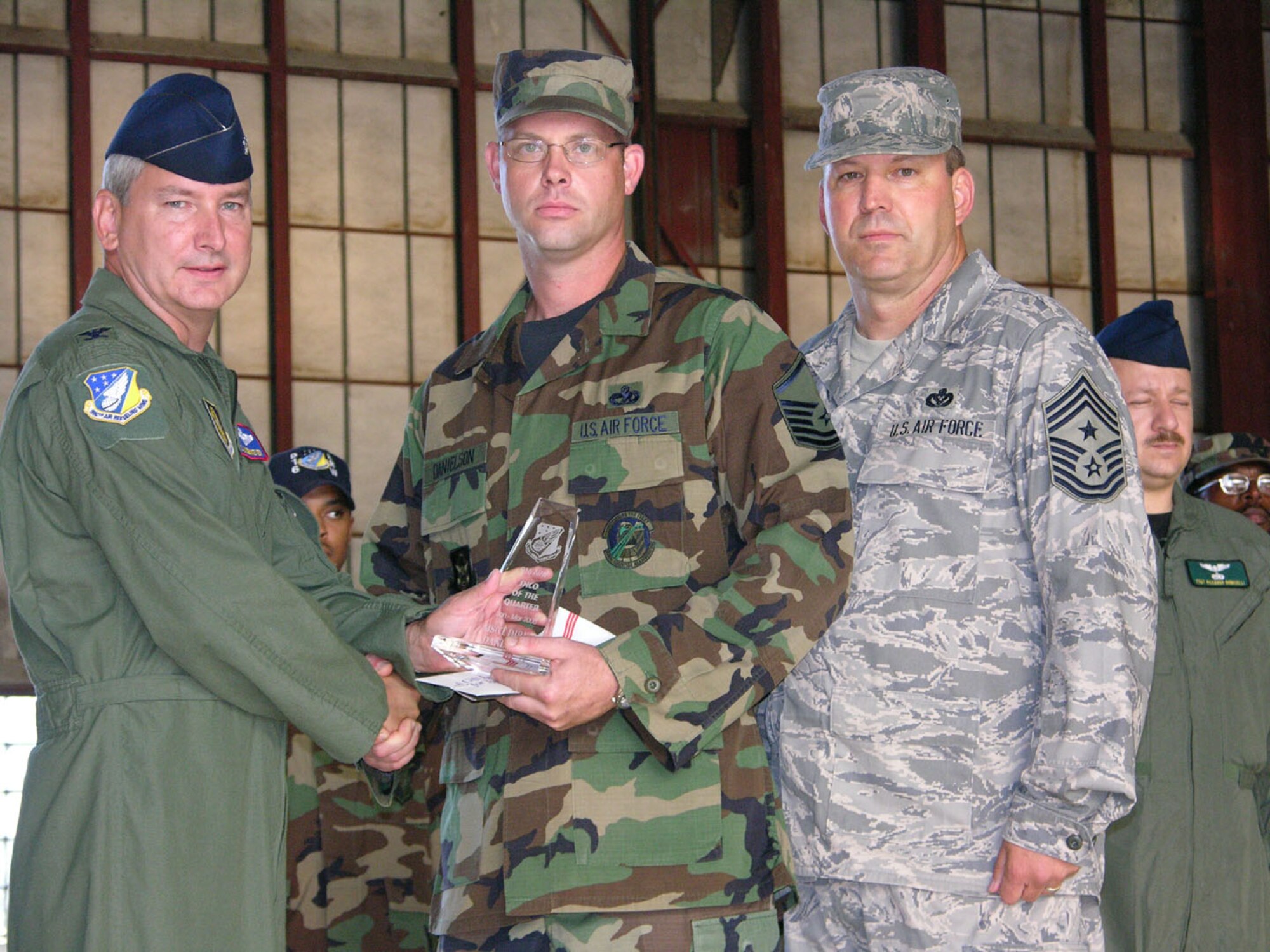 SEYMOUR JOHNSON AIR FORCE BASE, N.C. -- Master Sgt. Dirk Danielson (center) is recognized by Col. Fritz Linsenmeyer (left), commander of the 916th Air Refueling Wing and Command Chief Master Sgt. Lester Boltinhouse as the Senior Non-Commissioned Officer of the Quarter for January-March 2008. Sgt. Danielson is a Reservist with the 916th Logistics Readiness Squadron and serves as a vehicle operations and dispatch helper. U.S. Air Force photo/TSgt. Scotty Sweatt