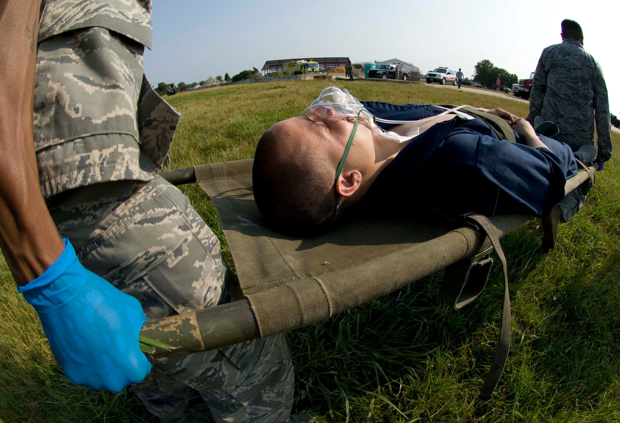 LANGLEY AIR FORCE BASE, Va. -- 1st Medical Group personnel carry Airman 1st Class Matthew Wiseman, simulated patient and 1st Aircraft Maintenance Squadron avionics system specialist, to an ambulance after he sustained simulated injuries during a major accident response exercise here June 11.  The MARE was conducted to train base personnel on emergency response procedures and to establish working agreements with local civilian agencies.  (U.S. Air Force photo/Senior Airman Barry Loo)