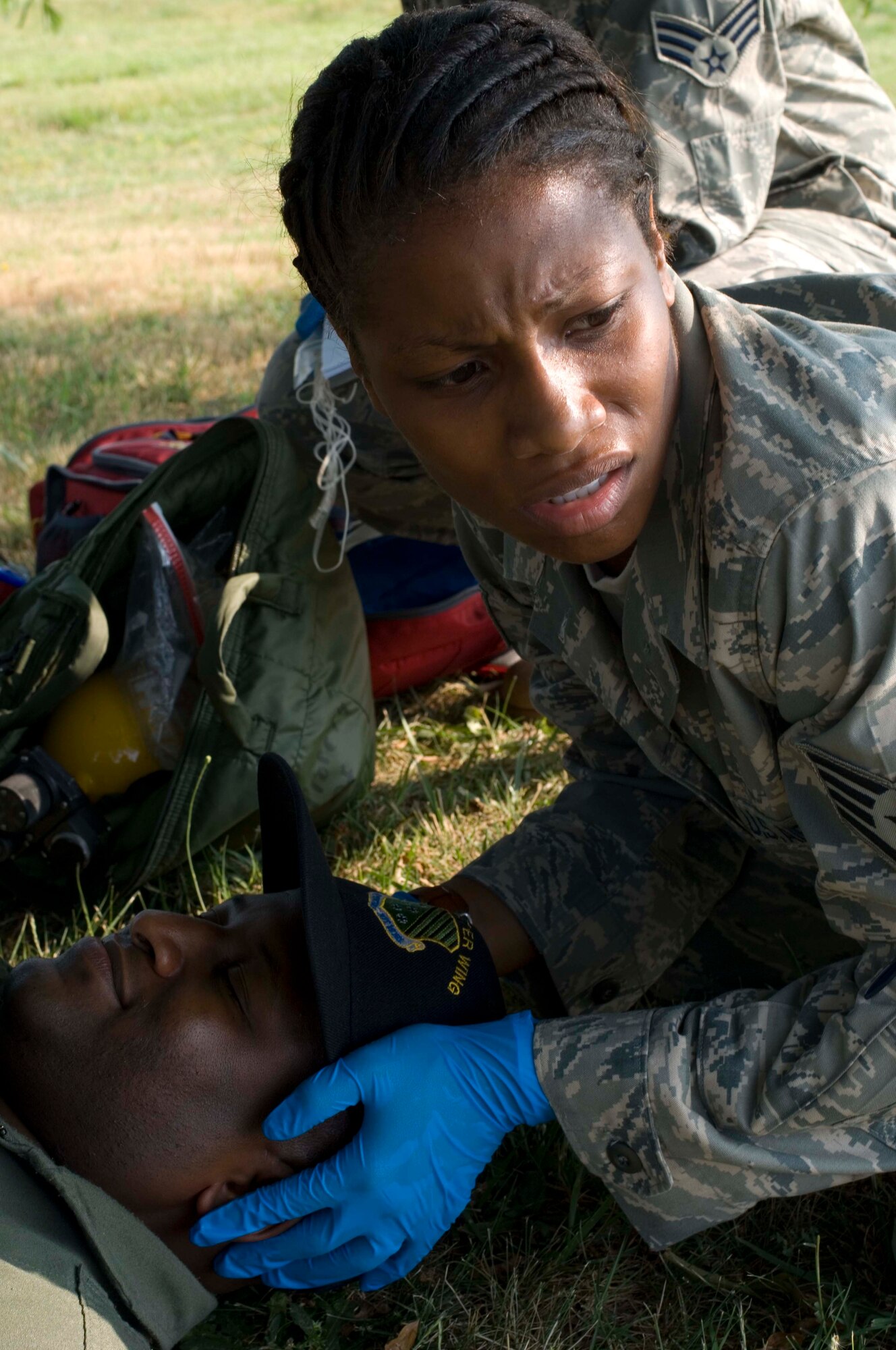 LANGLEY AIR FORCE BASE, Va. -- Staff Sgt. Alexis Lewis, 1st Medical Group medical technician, provides simulated medical care for simulated patient Tech. Sgt. Timothy Knowls, 1st Fighter Wing Plans and Programs noncommisioned officer in charge during a major accident response exercise here June 11.  The MARE was conducted to train base personnel on emergency response procedures and to establish working agreements with local civilian agencies.  (U.S. Air Force photo/Senior Airman Barry Loo)