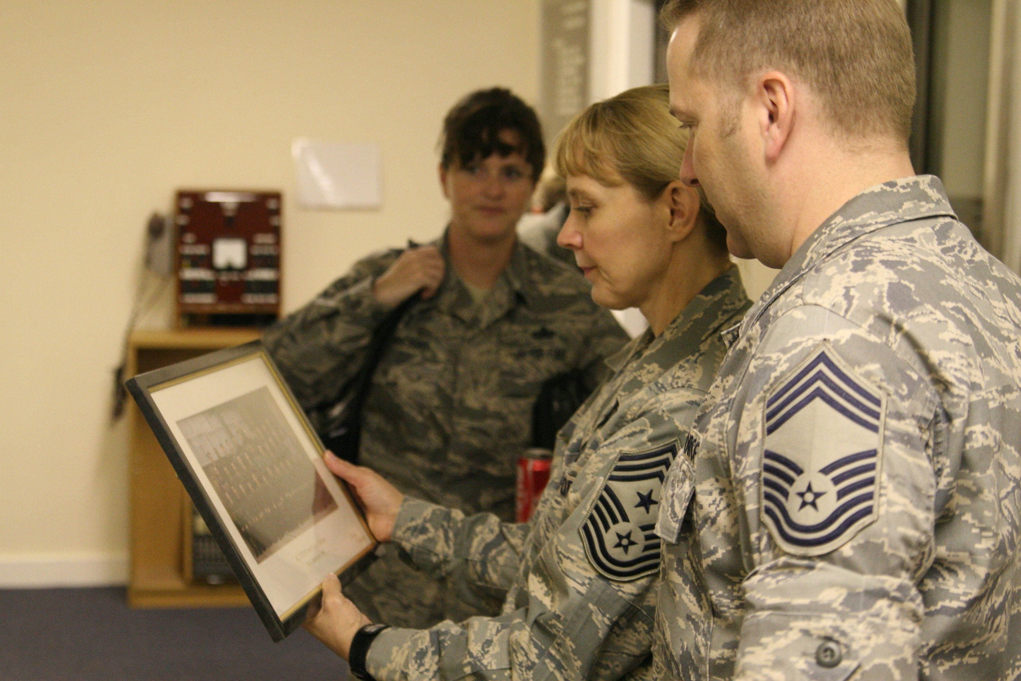 Chief Master Sgts Pamela Derrow, U.S. Air Forces Europe Command Chief, and John Young, 422nd Communications Squadron Superintendent look at an old photo in the 422nd CS headquarters at RAF Croughton on her June 4 visit to the base. RAF Croughton was Chief Master Sgt Derrow's first assignment and some of the communications equipment that was used during her tenure at the base is now on display in the squadron's Heritage Hall.
During her visit the Chief also held an enlisted call where she addressed issues facing RAF Croughton Airmen as well as Airman in general.