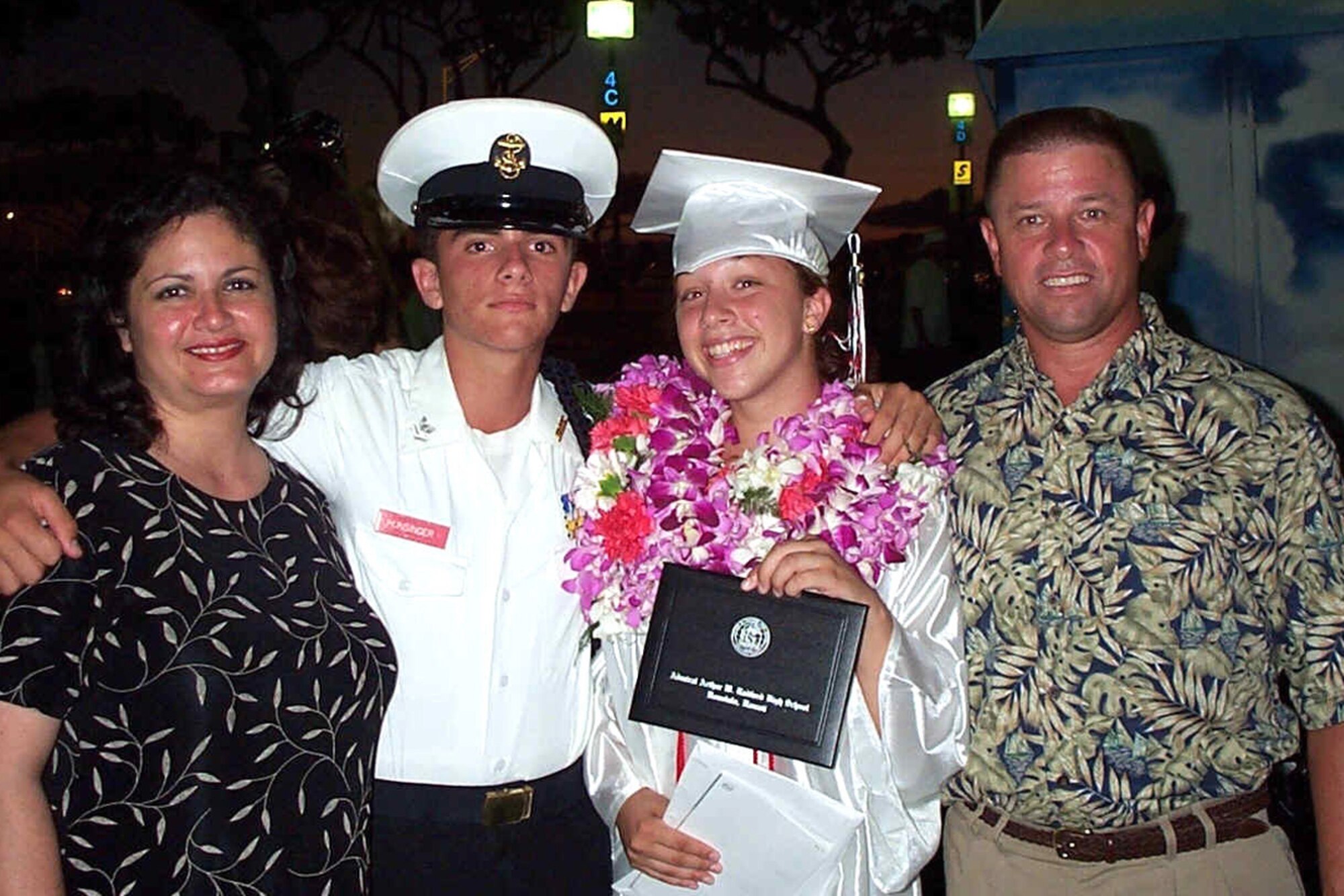SOUTHWEST ASIA -- Chief Master Sgt. Carl Hunsinger and wife Linda celebrate the graduation of their daughter Kathy with their youngest son Christopher following her Radford High School graduation ceremony in June 2003. The chief and his family were stationed at Hickam Air Force Base, Hawaii at the time. (U.S. Air Force courtesy photo)