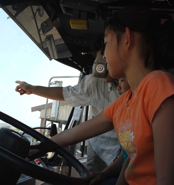 KUNSAN AIR BASE, Republic of Korea—Students form Seonyeon Elementary School in Kunsan City, Korea get a tour of the inside of a fire truck here June 12. The base tour gave the children an opportunity to see the Fighting Falcon up-close, interact with pilots, tour the base fire station and 8th Security Forces Squadron K-9 Kennel. 