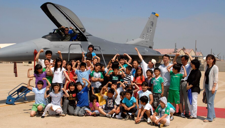 KUNSAN AIR BASE, Republic of Korea – Students and teachers from Seonyeon Elementary School in Kunsan City, Korea pose in front of an F-16 Fighting Falcon for a group photo here June 12. The base tour gave the children an opportunity to see the Fighting Falcon up-close, interact with pilots, tour the base fire station and 8th Security Forces Squadron K-9 Kennel.  