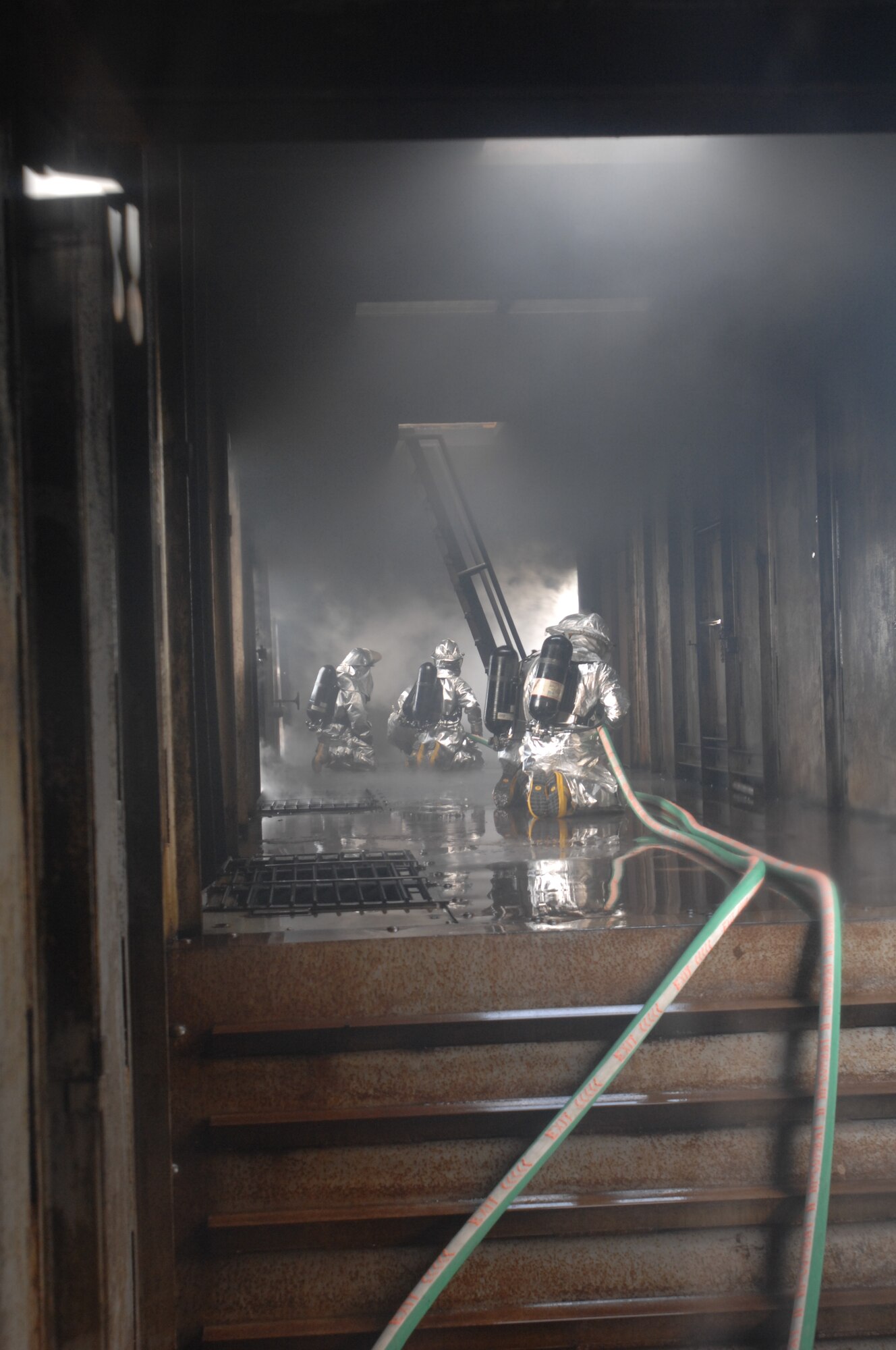 On May 22, 2008, firefighters from RAF Mildenhall, RAF Lakenheath, and Lajes Field finish battling a simulated aircraft fire during  training at the USAFE regional fire trainer at RAF Mildenhall. (U.S. Air Force Photo By Senior Airman Heather K. Stidham)