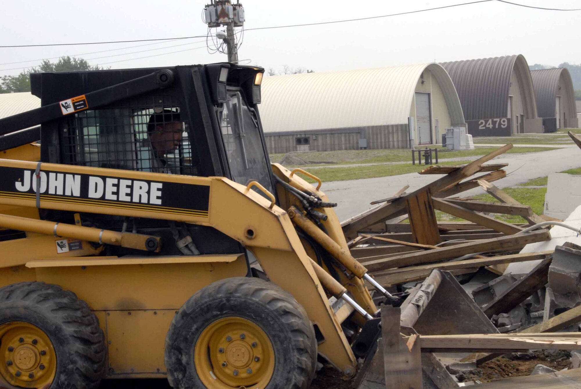 OSAN AIR BASE, Republic of Korea -- Col. Jon Norman, 51st Fighter Wing commander, bulldozes debris at Tent City June11. Construction on the new Tent City bath and shower structures is currently underway. (U.S. Air Force photo/Staff Sgt. Lakisha Croley)