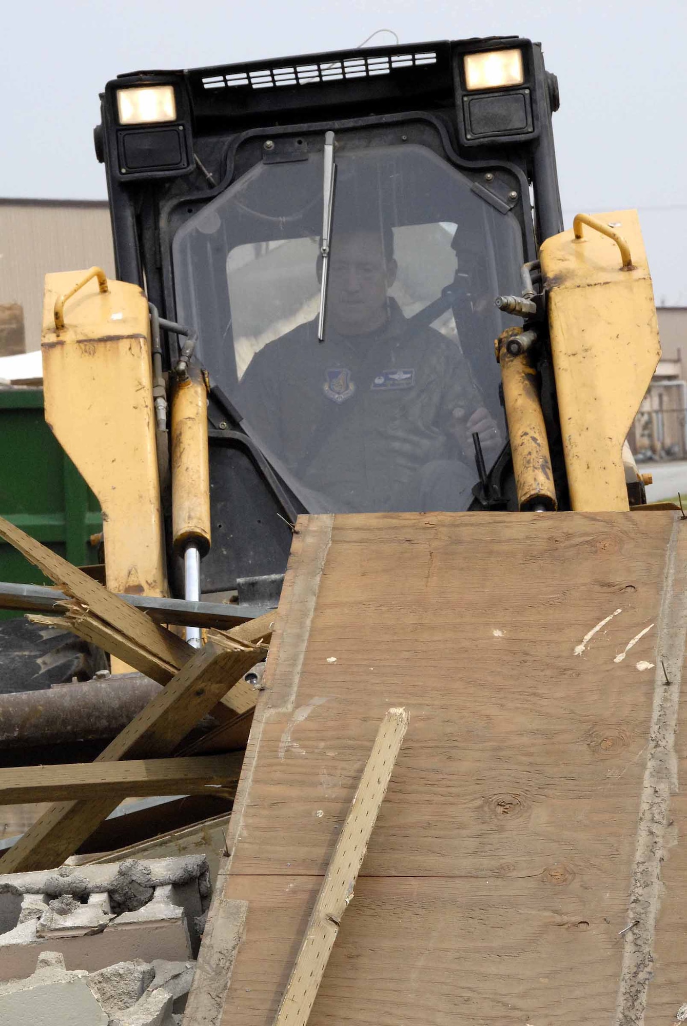 OSAN AIR BASE, Republic of Korea -- Col. Jon Norman, 51st Fighter Wing commander, bulldozes debris at Tent City June11. Construction on the new Tent City bath and shower structures is currently underway. (U.S. Air Force photo/Staff Sgt. Lakisha Croley)