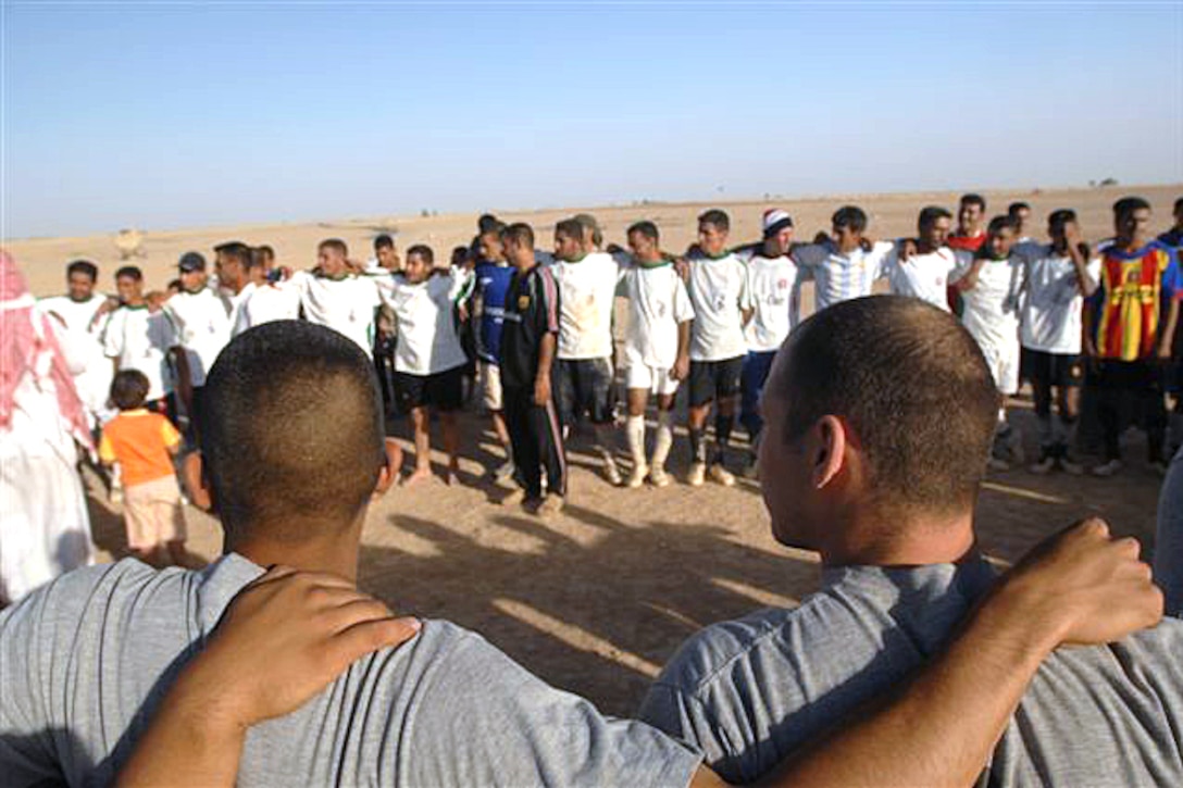 The 10th Mountain Division's 1st Battalion, 87th Infantry Regiment soccer team gather with the Mahus village soccer team at the end of their game in Mahus, June 5, 2008, to congratulate the Most Valuable Player. 