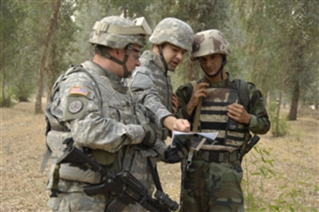 A U.S. Army soldier (left) from 3rd Squadron, 3rd Armored Cavalry Regiment and a U.S. Army Interpreter (center) look over a map with an Iraqi army soldier from 8th Brigade, 2nd Division before starting a cordon and search of the Ninewa Forest in Mosul, Iraq, on June 8, 2008.  