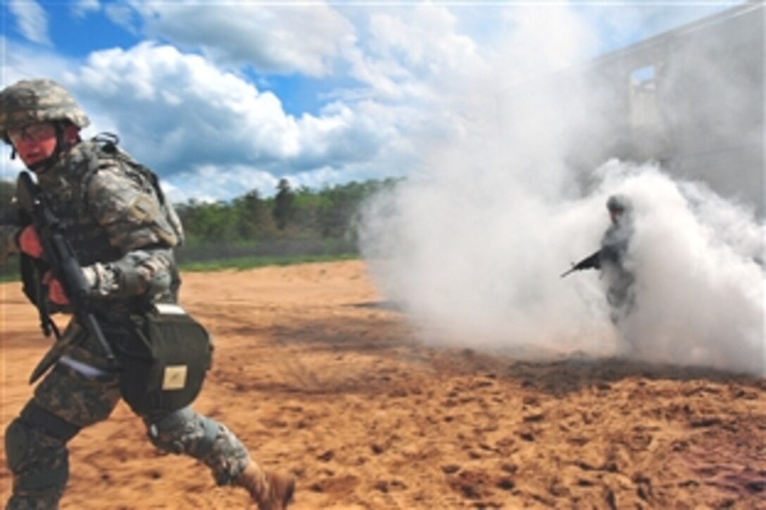 U.S. Army Lt. Col. Anthony Digiacomo, 1st Battalion, 137th Aviation Regiment commander, emerges through the smoke cloud during a training operation on Camp Grayling, Mich., June 10, 2008. 