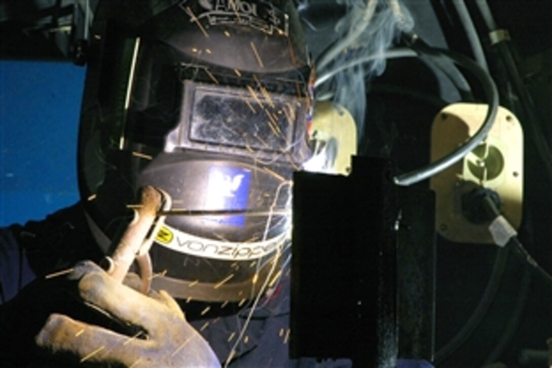U.S. Navy Petty Officer 3rd Class Josh Minster, a hull technician, practices welding for the sheet metal shop aboard the aircraft carrier USS John C. Stennis, Pacific Ocean, June 9, 2008. 
