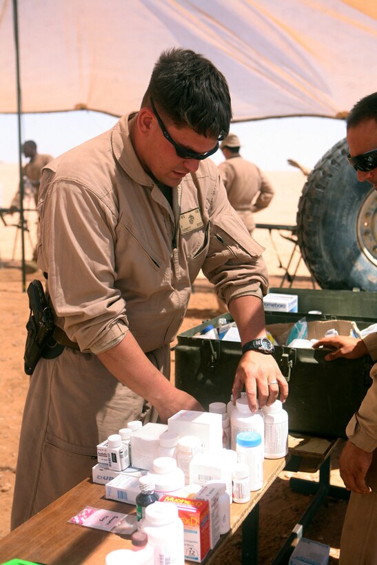 Organizing medicines to be provided to the residents of Nathara, Iraq, Petty Officer 3rd Class Robin Barrett, a line corpsman from Danville, Va., with Headquarters and Service Company, 2nd Light Armored Reconnaissance Battalion, Regimental Combat Team 5, ensures the correct medications are in stock for the people of the town. Corpsmen and surgeons from different units attached to Multi-National Force- West, Iraq, gathered together June 12 to provide care for the citizens of the small Iraqi village outside of Rutbah.