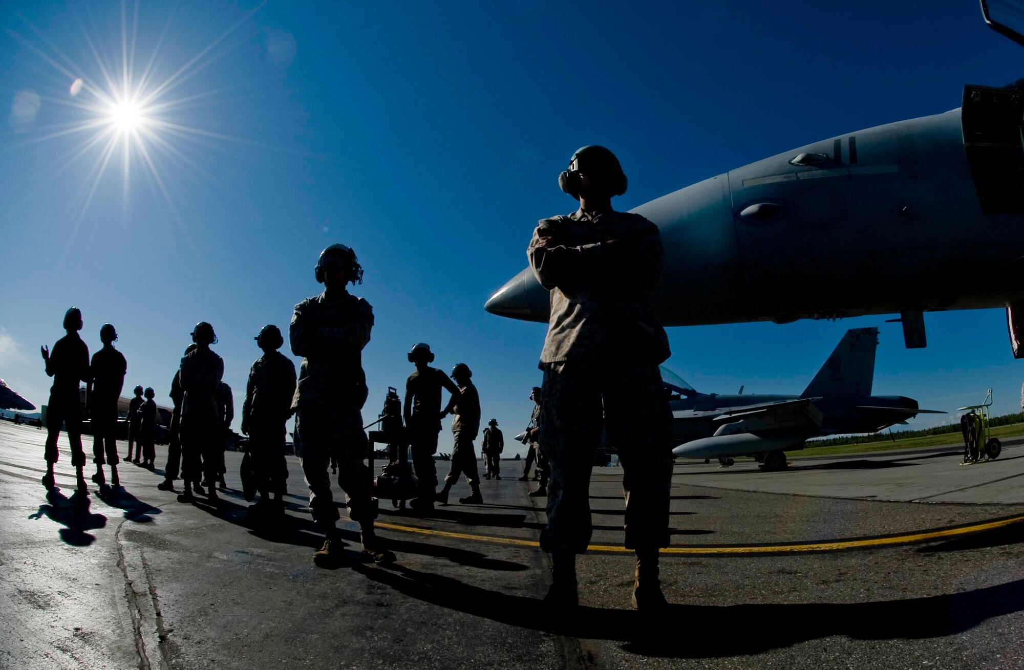 EIELSON AIR FORCE BASE, Alaska -- Marines of Miramar Naval Air Station watch as F-18 Hornets take taxi down the runway June 13, 2008. The Marines deployed from Miramar are participating in RED FLAG-Alaska 08-3 a series of Pacific Air Forces commander-directed field training exercises for U.S. forces, provides joint offensive counter-air, interdiction, close air support, and large force employment training in a simulated combat environment.  (U.S. Air Force photo by Airman 1st Class Christopher Griffin)