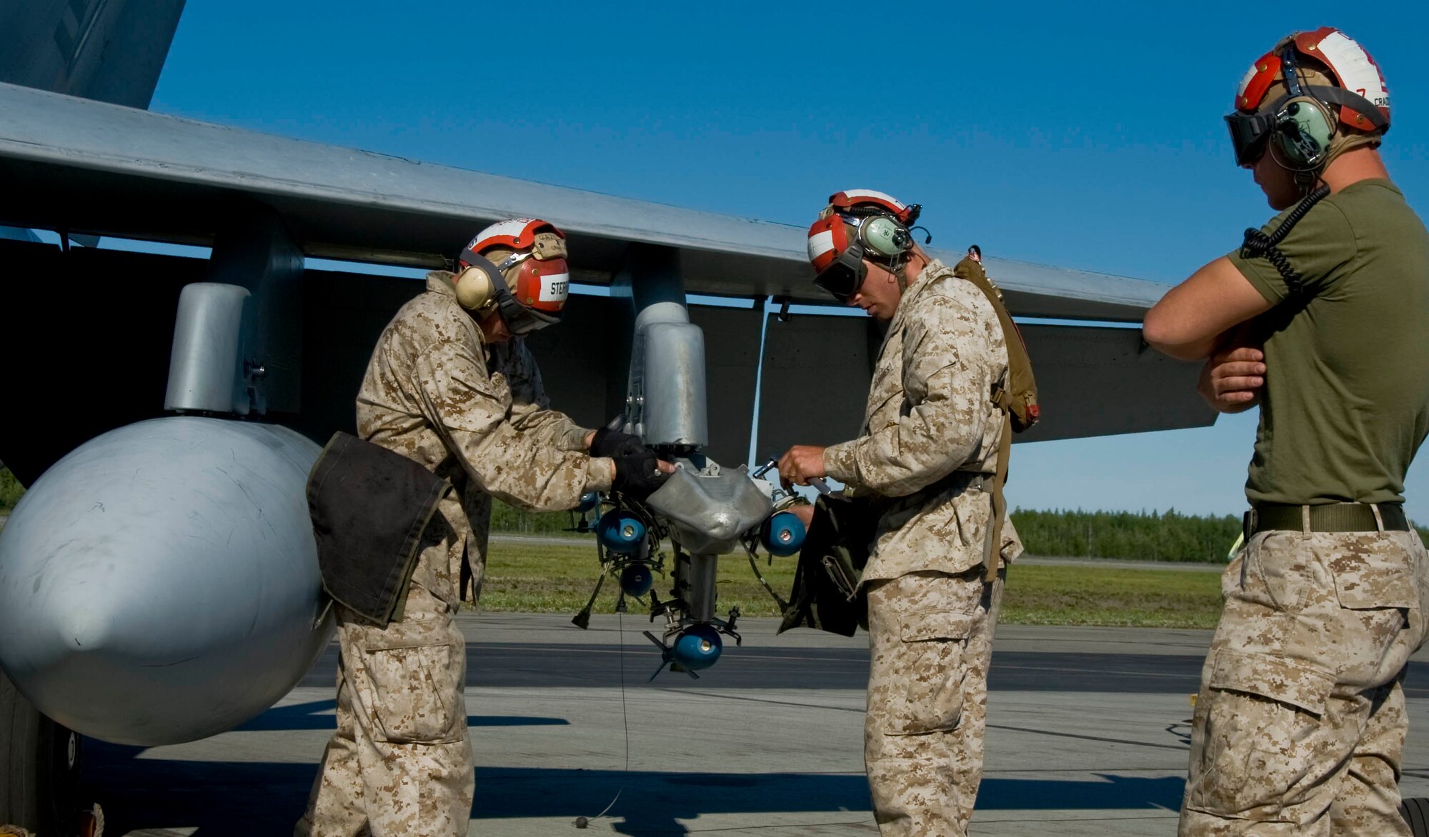 EIELSON AIR FORCE BASE, Alaska -- Lance Cpl. Sterrett and another member of Miramar Naval Air Station load explosive ordinance onto an F-18 Hornet June 13, 2008. The Marines deployed from Miramar are participating in RED FLAG-Alaska 08-3 a series of Pacific Air Forces commander-directed field training exercises for U.S. forces, provides joint offensive counter-air, interdiction, close air support, and large force employment training in a simulated combat environment.(U.S. Air Force photo by Airman 1st Class Christopher Griffin)