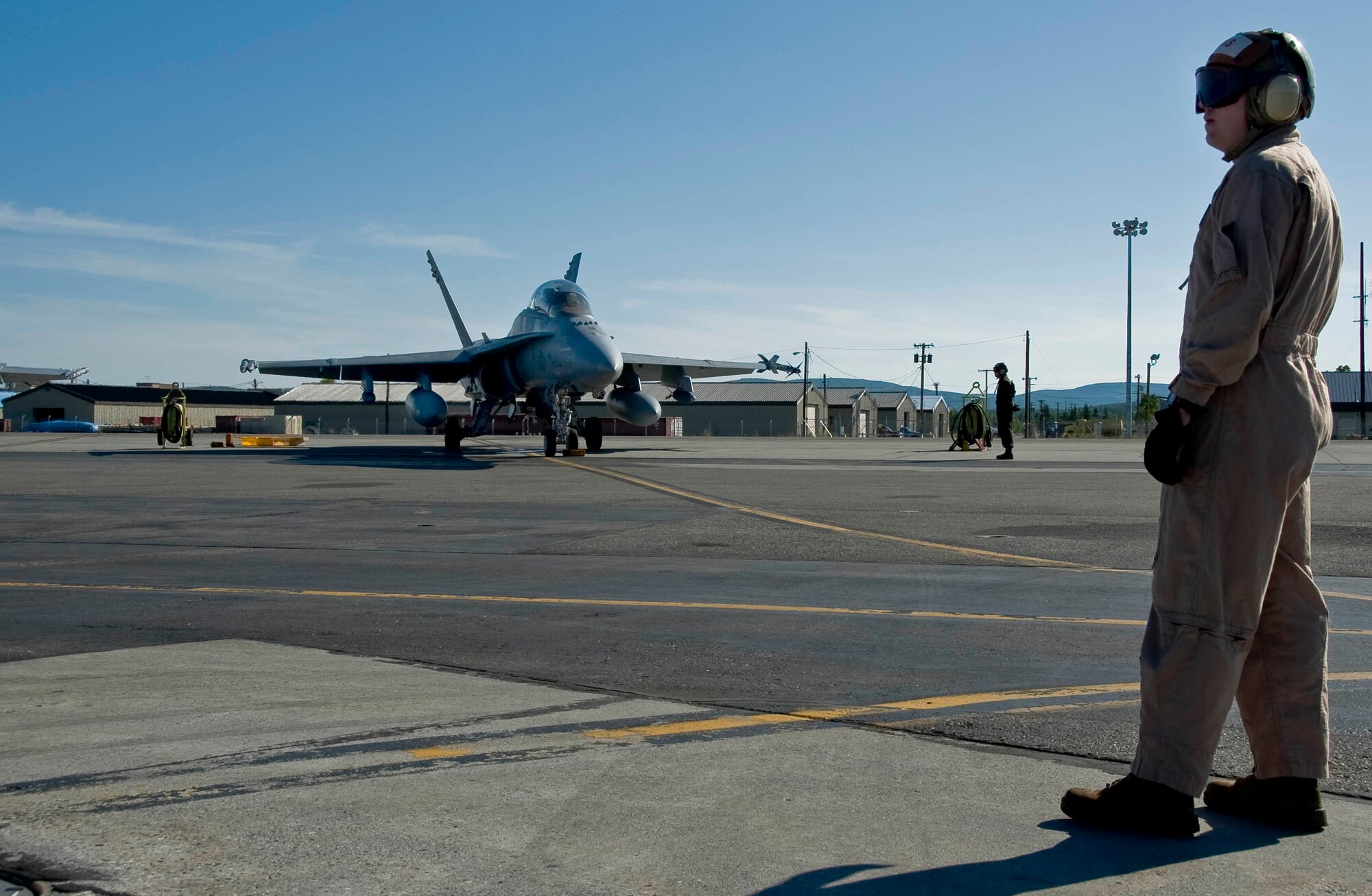 EIELSON AIR FORCE BASE, Alaska -- Marine Corps Staff Sgt. Hicks a crew chief from Miramar Naval Air Station awaits further instruction before marshaling the pilot of an F-18 Hornet to the taxiway June 13, 2008. The Marines deployed from Miramar are participating in RED FLAG-Alaska 08-3, a 10-day air combat training exercise held up to four times a year.  (U.S. Air Force photo by Airman 1st Class Christopher Griffin)