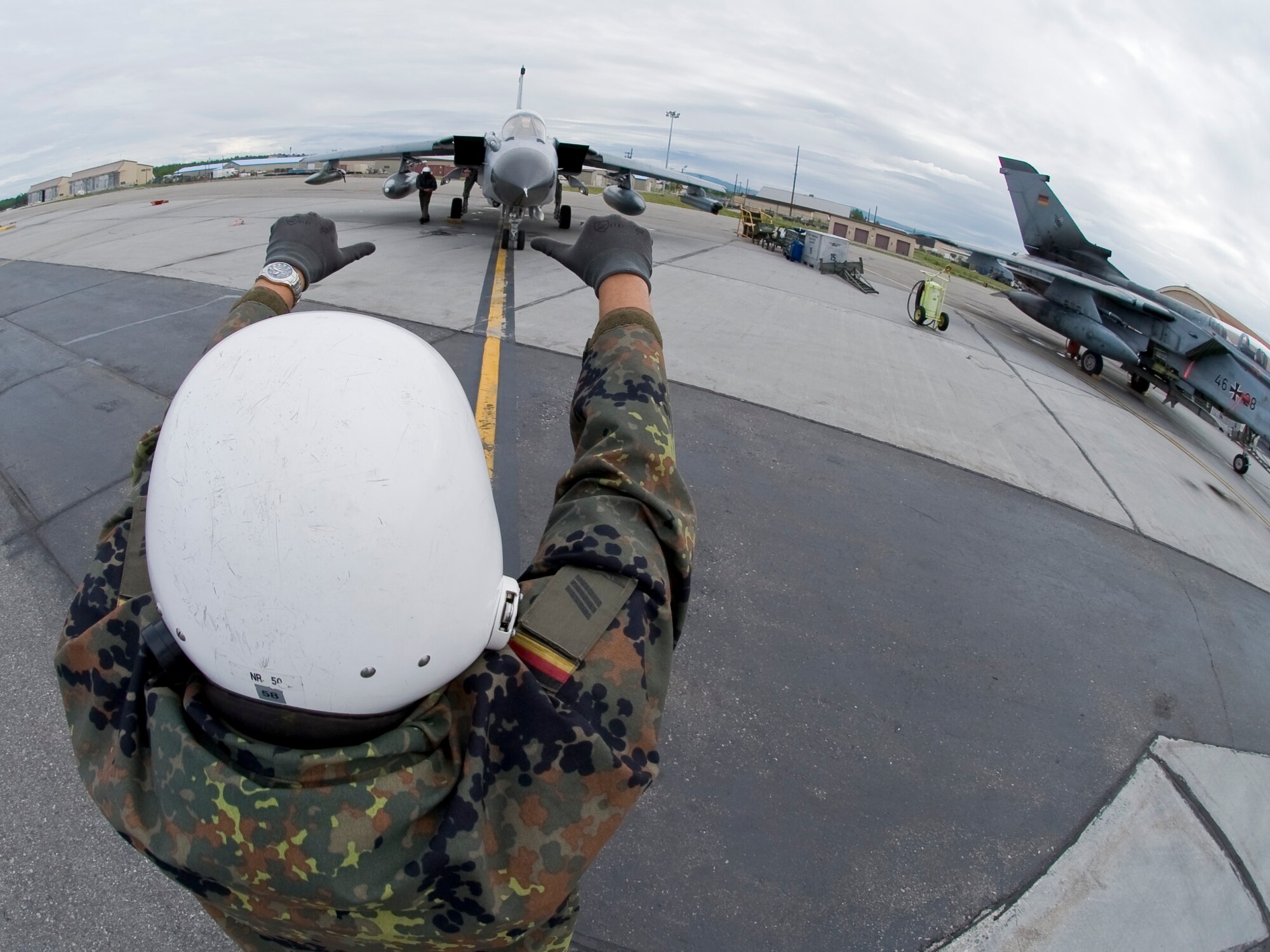 EIELSON AIR FORCE BASE, Alaska --A German Air Force crew chief marshals the pilot of a Tornado to the runway of the Eielson flight line June 12, 2008. Red Flag-Alaska, a series of Pacific Air Forces commander-directed field training exercises for U.S. forces, provides joint offensive counter-air, interdiction, close air support, and large force employment training in a simulated combat environment.
  (U.S. Air Force photo by Airman 1st Class Christopher Griffin) 