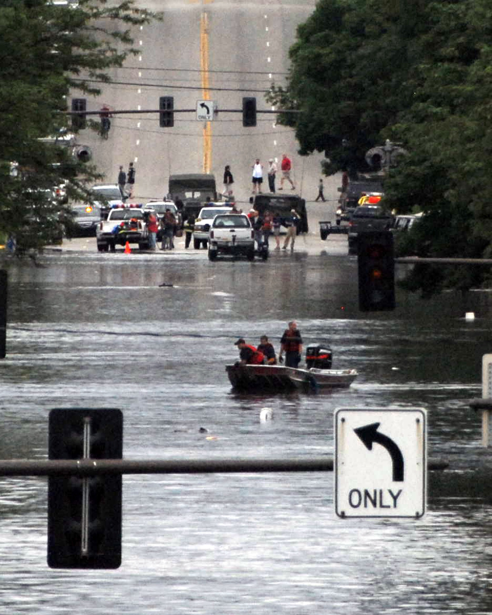 The Iowa National Guard members assist local police with traffic and crowd control, as search and rescue teams patrol for citizens left stranded by the rapidly rising flood waters in Cedar Rapids, Iowa. The Air and Army Guards joined forces with local authorities to protect flooded areas and providing general assistance to the public. 
OFFICIAL AIR FORCE PHOTO by SSG OSCAR SANCHEZ