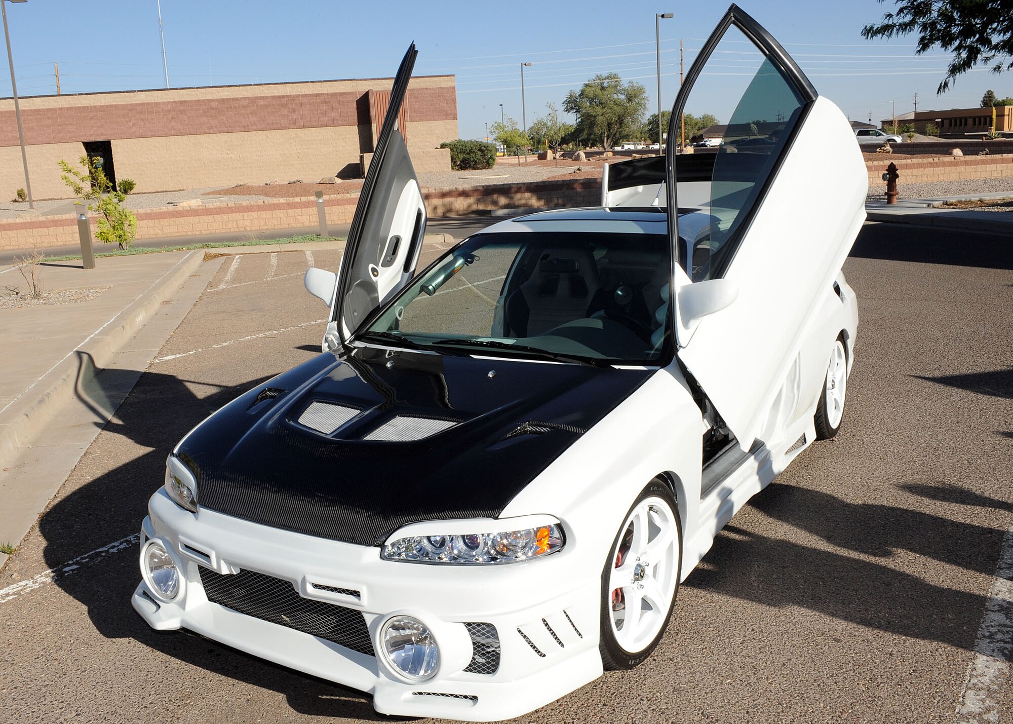 Carloz Diaz husband of Staff Sgt. Soly Diaz shows off his tricked out car at the Airman and Family Readiness Center on Holloman Air Force Base, N.M. Wednesday, June 11. The Airman and Family Readiness Center put on a car show in promotion of their Families Apart Dinner. (U.S Air Force photo/ Airman 1st Class Deandre Curtiss)  