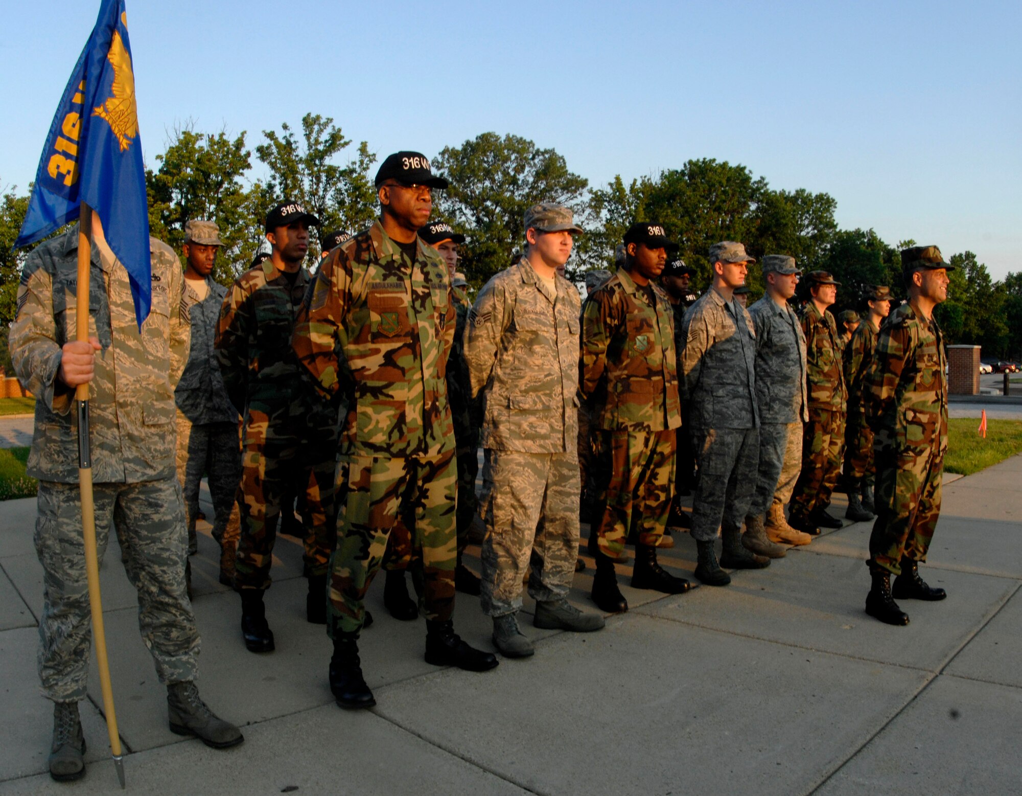 Members from the 316th Wing Staff form up for reveille in honor of National Flag Day on June 13.  Flag Day commemorates the adoption of the flag of the United States originating in 1777. (U.S. Air Force photo/Senior Airman Steven R. Doty)