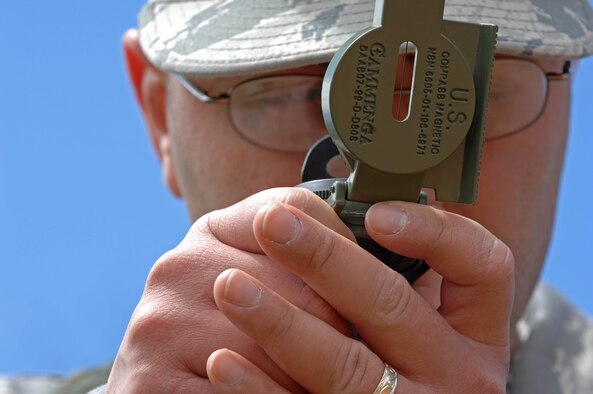 Staff Sgt. Ivan Vicente, 28th Medical Operations Squadron ambulance services medical technician, uses a compass to pinpoint specific points of latitude and longitude at Camp Rapid, S.D., June 10. During Golden Coyote 2008, three teams were assigned different points to locate throughout Camp Rapid during the land navigation event. (U.S. Air Force photo/Airman Corey Hook) 
