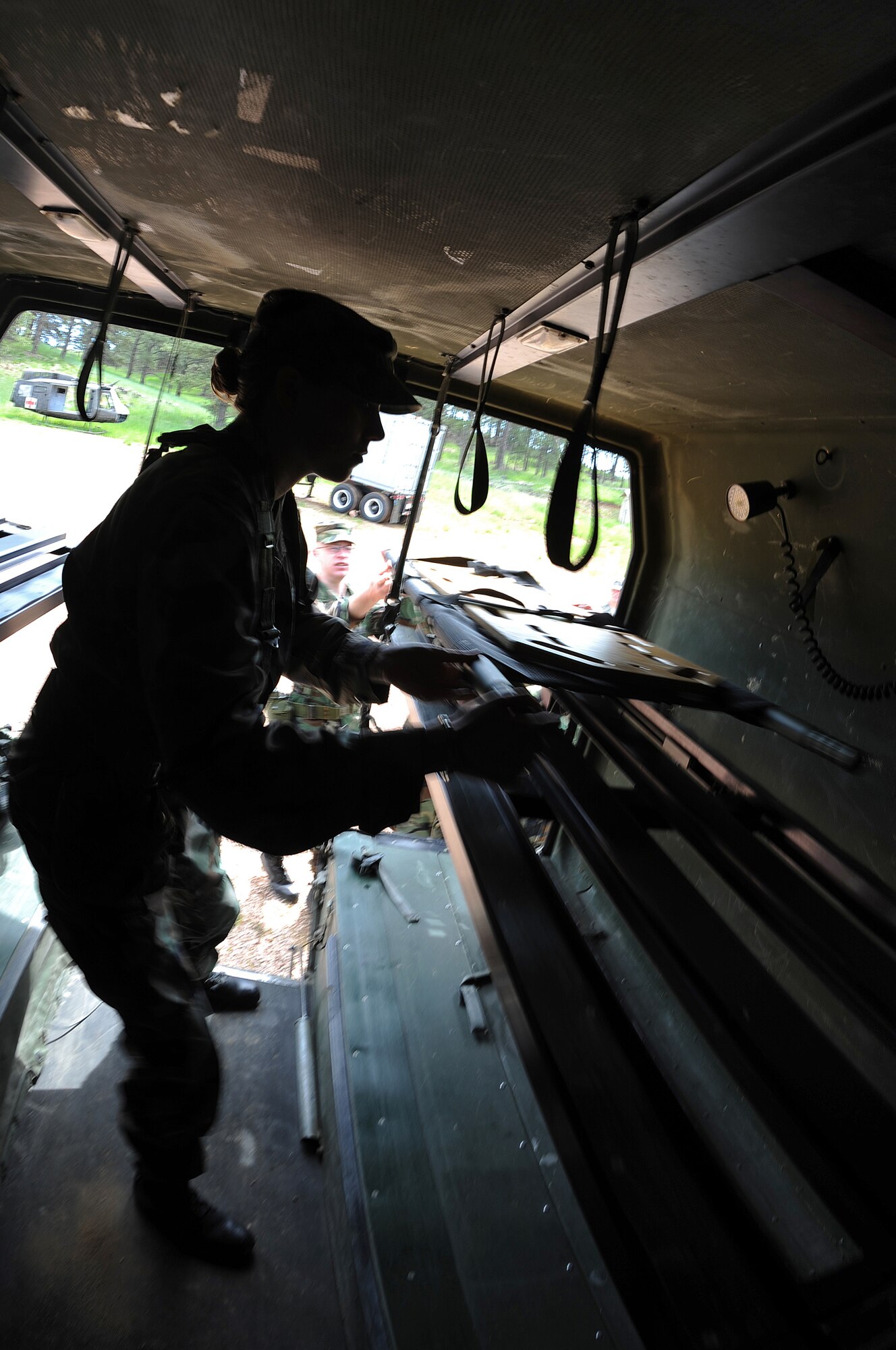 As part of The Golden Coyote training exercise, Senior Airman Jordan Brown, Ellsworth Air Force Base 28th Medical Group medical logistics journeyman, loads a litter into a ground ambulance at Camp Rapid, Rapid City, S.D., June 9, 2008. Golden Coyote tests the ability of engineering and support units to mobilize equipment, deploy to a battle zone, coordinate combat and service support missions and re-deploy back to home station. (U.S. Air Force photo/Senior Airman Marc I. Lane)