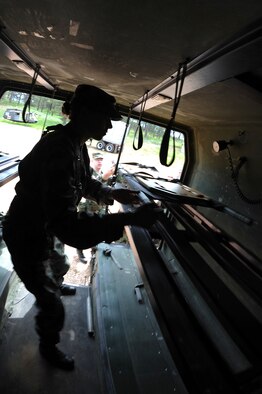 As part of the Golden Coyote training exercise, Senior Airman Jordan Brown, Ellsworth Air Force Base 28th Medical Group medical logistics journeyman, loads a litter into a ground ambulance at Camp Rapid, Rapid City, S.D., June 9. Golden Coyote tests the ability of engineering and support units to mobilize equipment, deploy to a battle zone, coordinate combat and service support missions and re-deploy back to home station. (U.S. Air Force photo/Senior Airman Marc I. Lane) 
