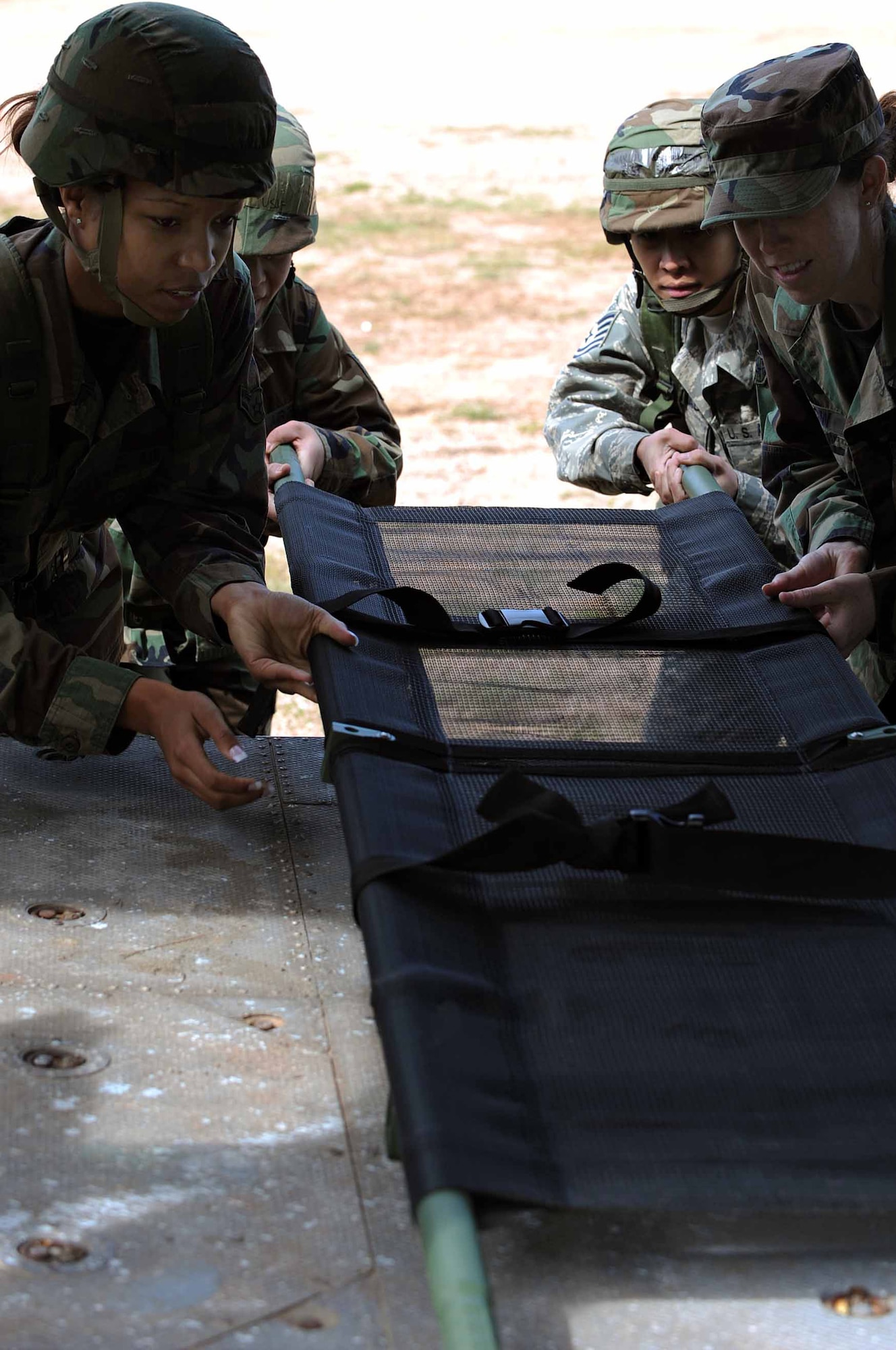 As part of The Golden Coyote training exercise, members of the Ellsworth Air Force Base 28th Medical Group practice litter movement and loading at Camp Rapid, Rapid City, S.D., June 9, 2008. Golden Coyote tests the ability of engineering and support units to mobilize equipment, deploy to a battle zone, coordinate combat and service support missions and re-deploy back to home station. (U.S. Air Force photo/Senior Airman Marc I. Lane)