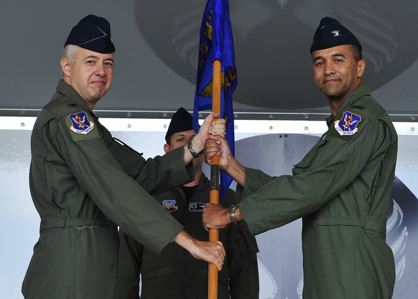 MOODY AIR FORCE BASE, Ga. -- Col. Kenneth Todorov, 23rd Wing commander, passes the guideon to Col. Darryle Grimes, 347th Rescue Group commander, during a change-of-command ceremony here June 13. Colonel Grimes took command of the group from Col. Eric Kivi, who commanded the group for the past two years. (U.S. Air Force photo by Senior Airman Elizaberth Rissmiller) 

