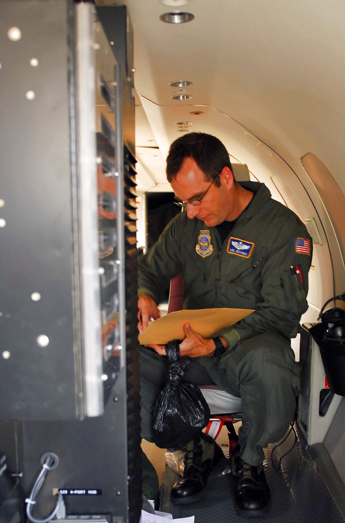 Maj. Mark Jeffries packs up after a flood damage assessment flight in Indiana June 11 on board an RC-26. Major Jeffries was one of several pilots to fly over Indiana in the RC-26 providing live footage of the area for the Indiana National Guard. Major Jeffries is a mission systems officer in the 130th Airlift Wing in Charleston, W.V. (US Army photo/Spc. Cassandra Groce) 
