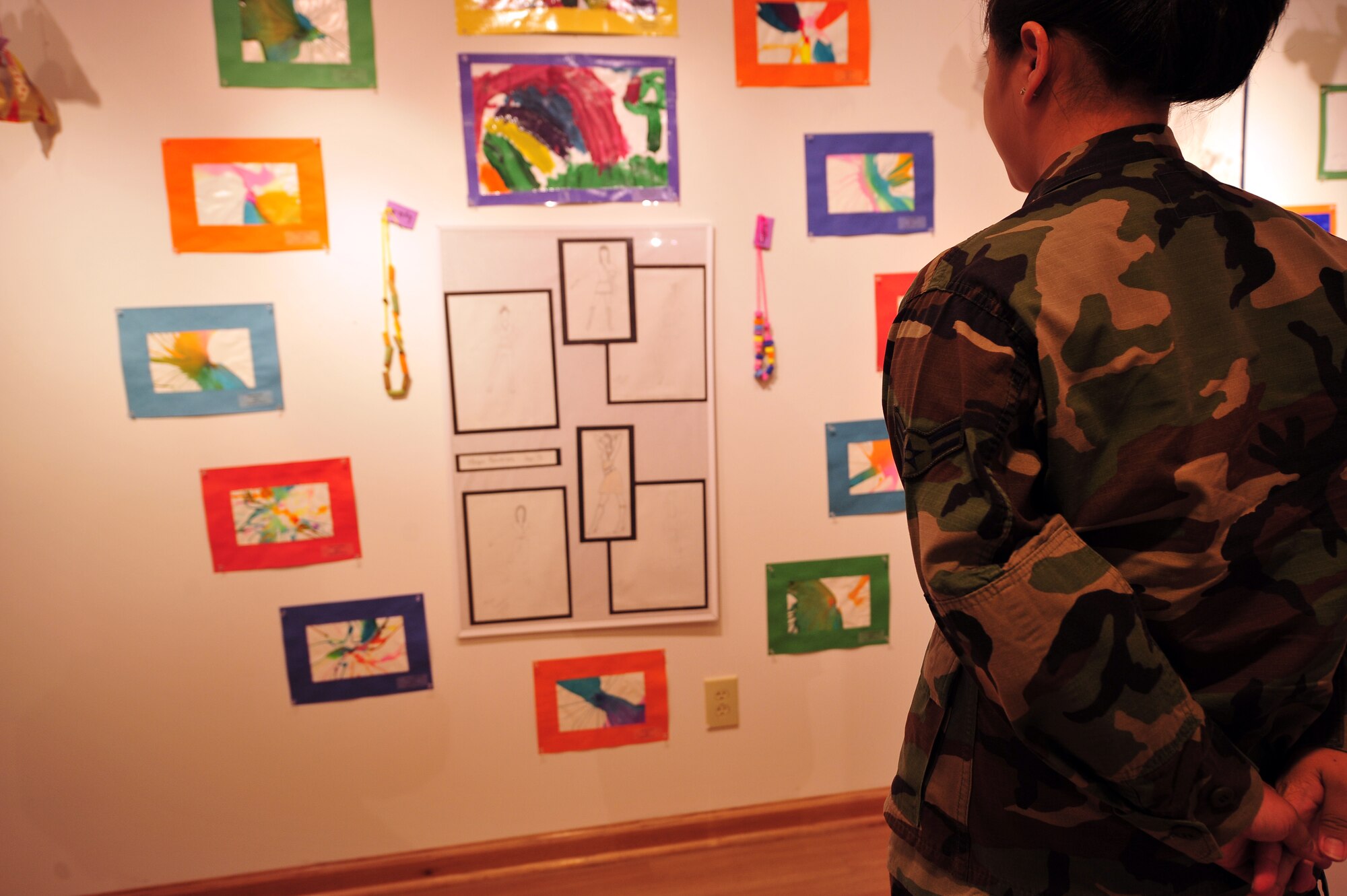 MOODY AIR FORCE BASE, Ga. -- An Airman looks at artwork at the Annette Howell Turner Center for the Arts in Valdosta, June 13. Moody’s children and youth recently joined together to create the art display for the community to enjoy.  The display can be viewed at the Howell Center through August 6. (U.S. Air Force photo by Senior Airman Elizabeth Rissmiller)