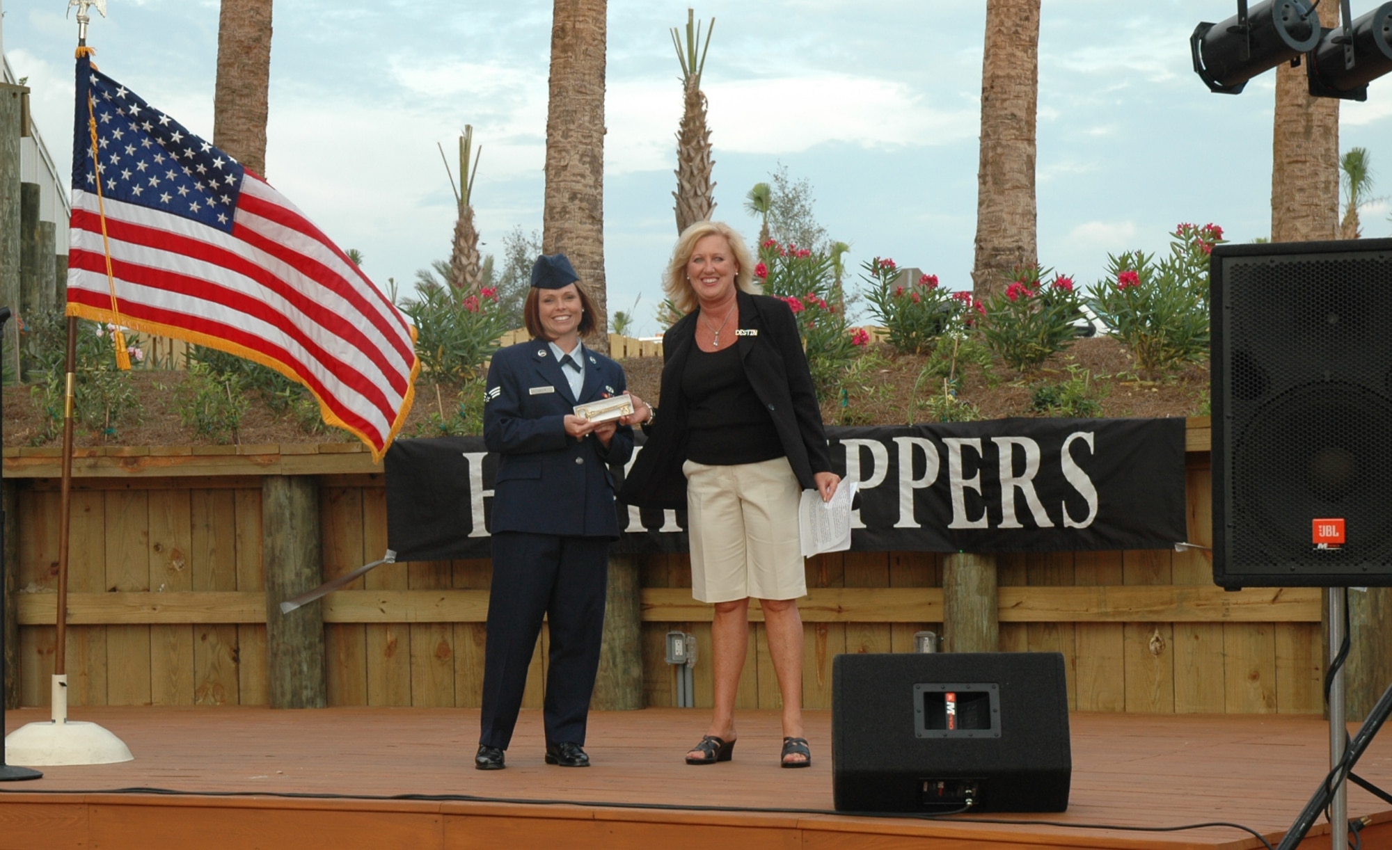 Senior Airman Christina Lilly is presented with a key to the city of Destin June 12 as part of the city's Red, White and Blue Celebration during the Destin Harbor Summer Festival at the HarborWalk Village. Senior Airman Lilly was selected to be recognized in the summer-long event, in which tribute will be paid to military members from Eglin Air Force Base, Hurlburt Field and Duke Field every Thursday night throughout the summer for their above and beyond accomplishments. Other reservists to be recognized include Senior Master Sgt. Leonard Jordan on July 3, Tech. Sgt. Michael Biseinere on July 24, and Capt. Carmel Weed on Aug. 14. (U.S. Air Force Photo/Maj. Terry Lisenbee)