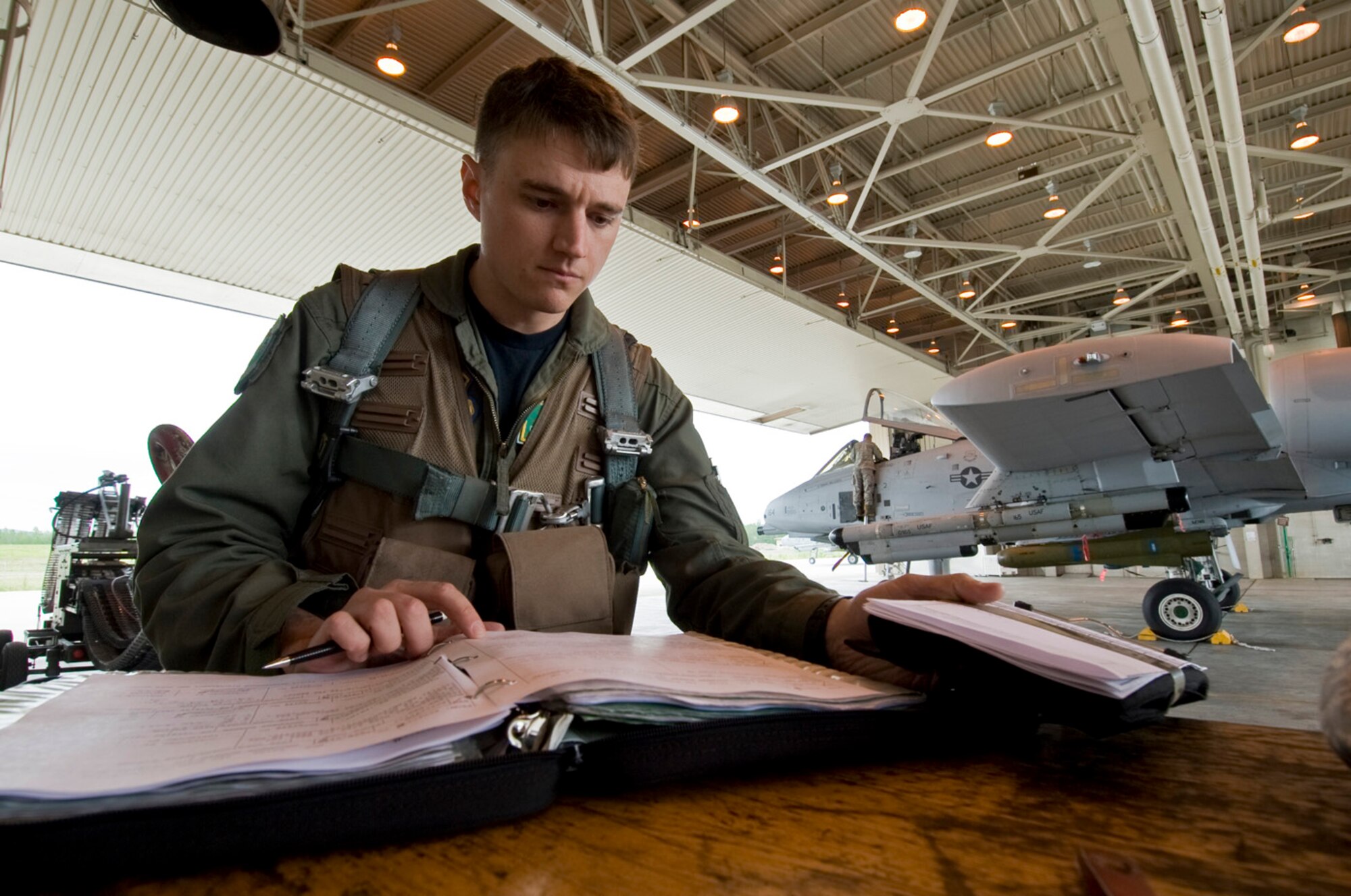 Maj. Daryl Komulainen reviews his pre-flight inspection log June 12, 2008, at Eielson Air Force Base, Alaska during RED FLAG-Alaska 08-3. This a series of Pacific Air Forces commander-directed field training exercises for U.S. forces, provides joint offensive counter-air, interdiction, close air support, and large force employment training in a simulated combat environment. He is assigned to the 25th Fighter Squadron at Osan Air Base, Korea. (U.S. Air Force Photo/Airman 1st Class Jonathan Snyder)