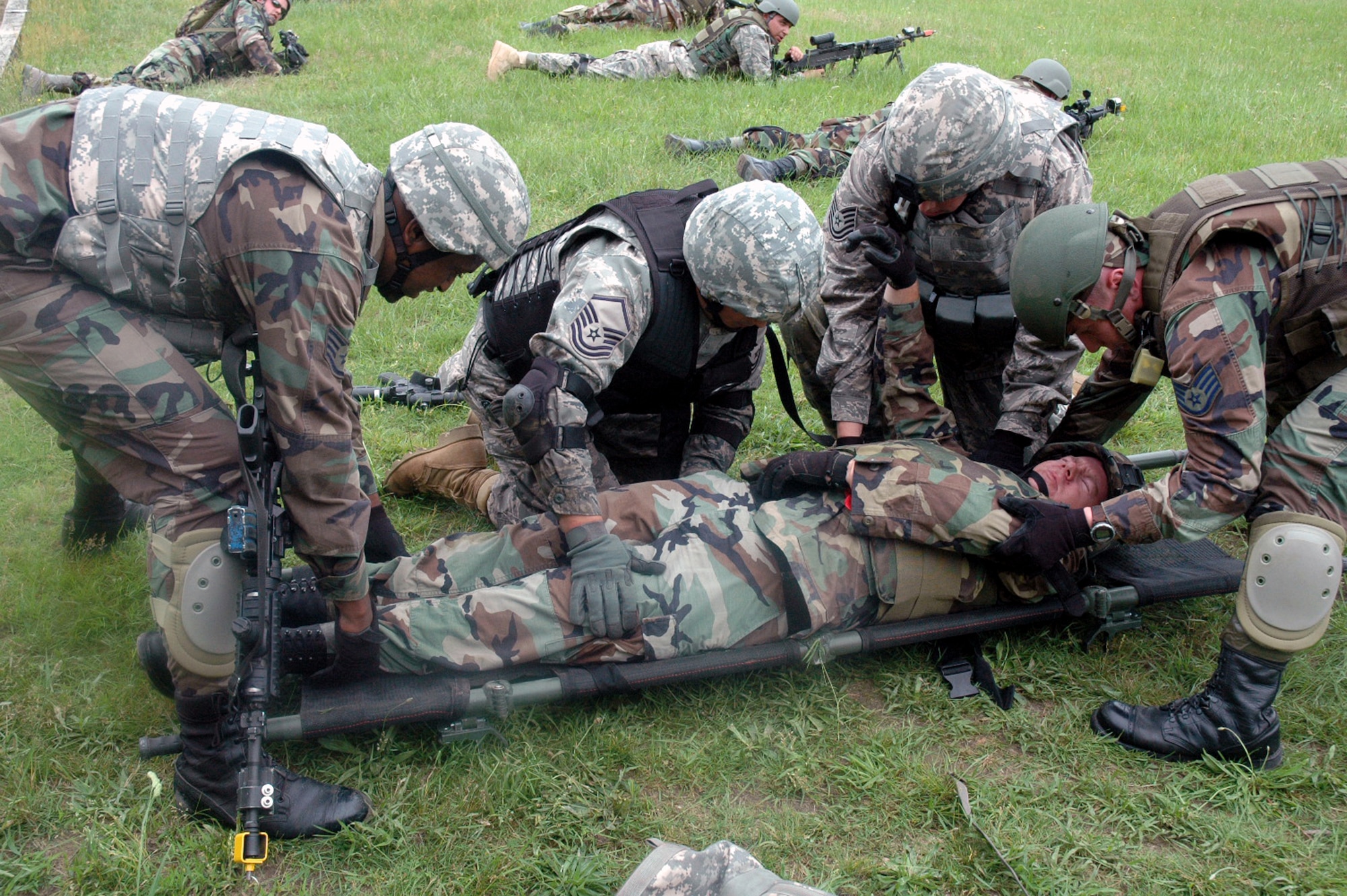Students in the Air Force Phoenix Warrior Training Course 08-5 prepare to transport a "victim" during training in a combat first aid class on a Fort Dix, N.J., range June 5, 2008.  The course is taught by the U.S. Air Force Expeditionary Center's Expeditionary Operations School and 421st Combat Training Squadron and prepares security forces Airmen for upcoming deployments. Annually, the USAF EC trains more than 23,000 students in expeditionary- and mobility air force-based courses both with in-residence and distance learning.  (U.S. Air Force Photo/Tech. Sgt. Scott T. Sturkol)