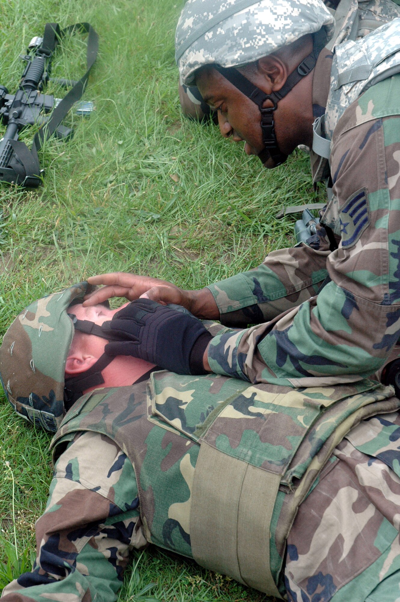 A student in the Air Force Phoenix Warrior Training Course 08-5 tends to a "victim" during training in a combat first aid class on a Fort Dix, N.J., range June 5, 2008.  The course is taught by the U.S. Air Force Expeditionary Center's Expeditionary Operations School and 421st Combat Training Squadron and prepares security forces Airmen for upcoming deployments. Annually, the USAF EC trains more than 23,000 students in expeditionary- and mobility air force-based courses both with in-residence and distance learning.  (U.S. Air Force Photo/Tech. Sgt. Scott T. Sturkol)