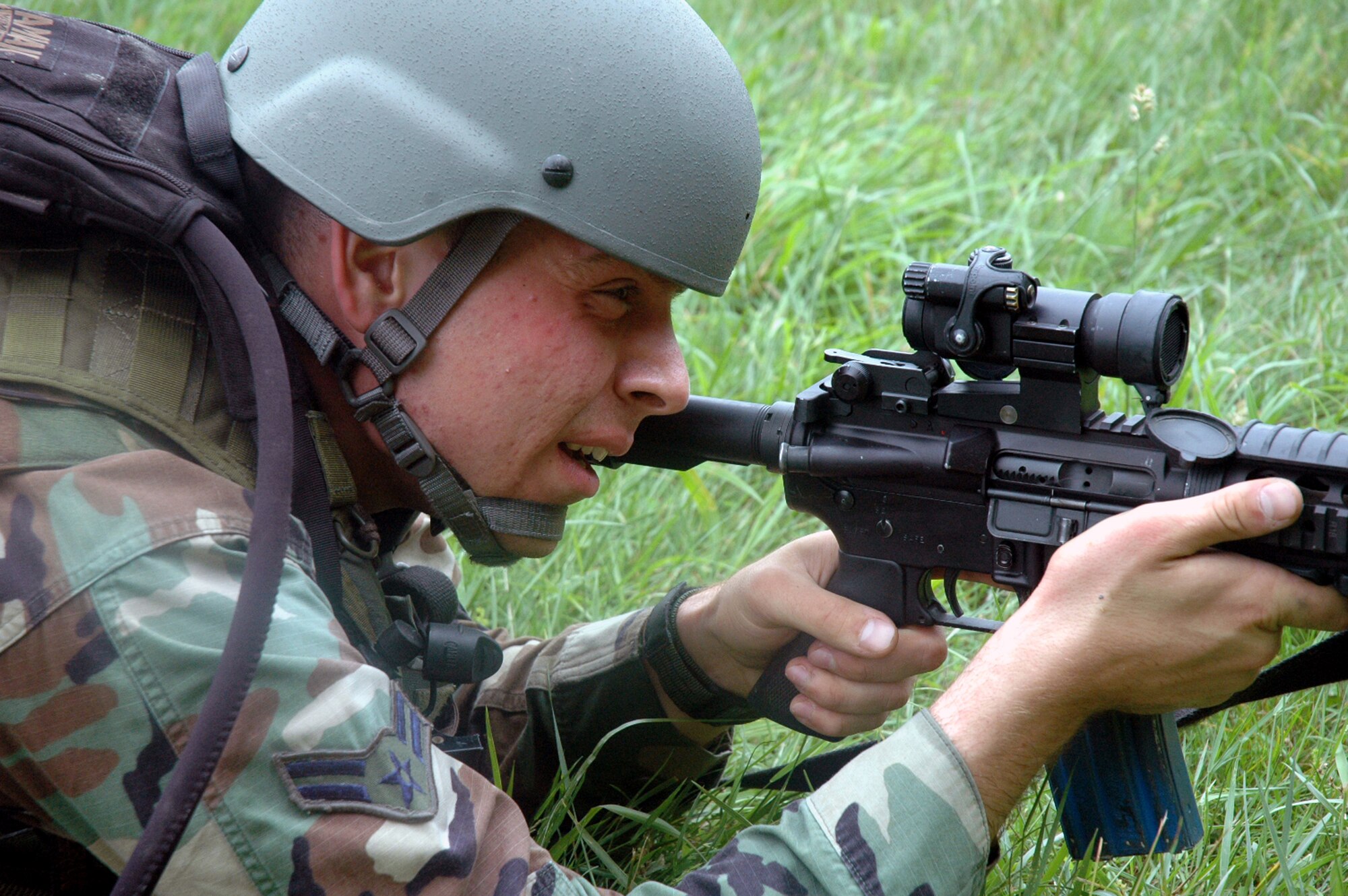 A student in the Air Force Phoenix Warrior Training Course 08-5 provides security during training in a combat first aid class on a Fort Dix, N.J., range June 5, 2008.  The course is taught by the U.S. Air Force Expeditionary Center's Expeditionary Operations School and 421st Combat Training Squadron and prepares security forces Airmen for upcoming deployments. Annually, the USAF EC trains more than 23,000 students in expeditionary- and mobility air force-based courses both with in-residence and distance learning.  (U.S. Air Force Photo/Tech. Sgt. Scott T. Sturkol)