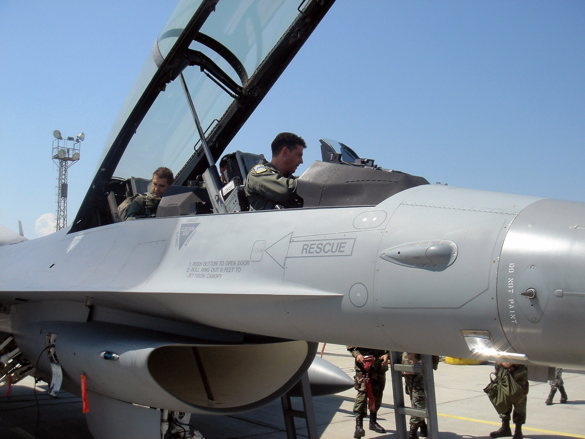 Lt. Col. Jose Monteagudo prepares to take Bulgarian Defense Minister Nikolay Tsonev (backseat) on a flight in an F-16 Fighting Falcon June 11 at Graf Ignatievo Air Base, Bulgaria. Colonel Monteagudo and 10 F-16s from the 93rd Fighter Squadron at Homestead Air Reserve Base, Fla., are at Graf Ignatievo AB to particpate in a joint drill with 15 Bulgarian MiG-21 and MiG-29 fighters. MInister Tsenov visited the base to see how the joint drill was progressing. Colonel Monteagudo is an F-16 pilot from the 482nd Fighter Wing. (Courtesy photo/Darik Plovdiv) 
