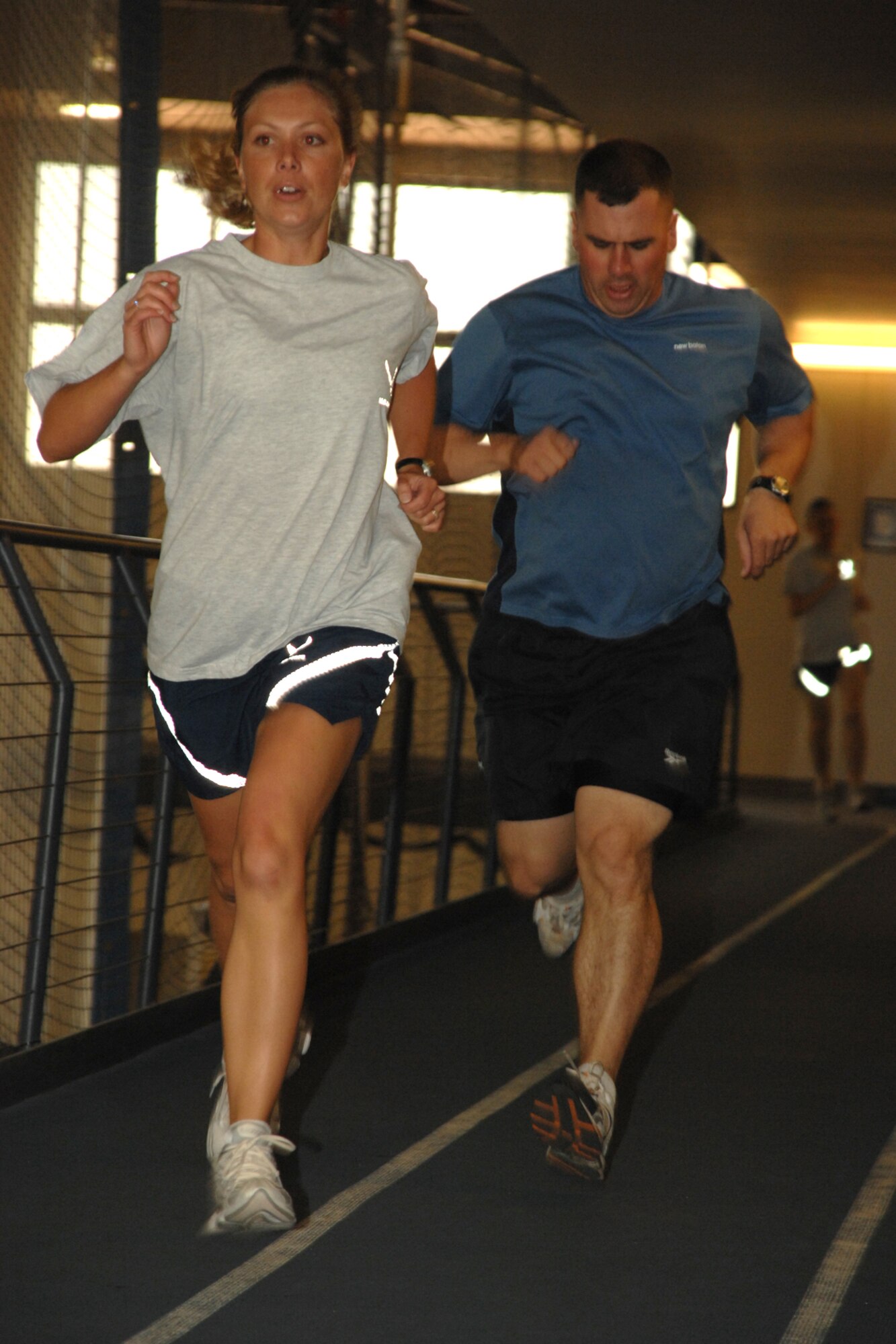 Senior Airman Sheri Mason and Staff Sgt. Cullen Combs, both from the 49th Civil Engineer Sqaudron, give it their all during the mile and a half portion of the Team Iron Airman Challenge June 11 at the Fitness and Sports Center at Holloman Air Force Base, N.M. Run times were scored based on the Air Force Physical Training scoring system. (U.S. Air Force photo/Airman 1st Class Jamal D. Sutter)