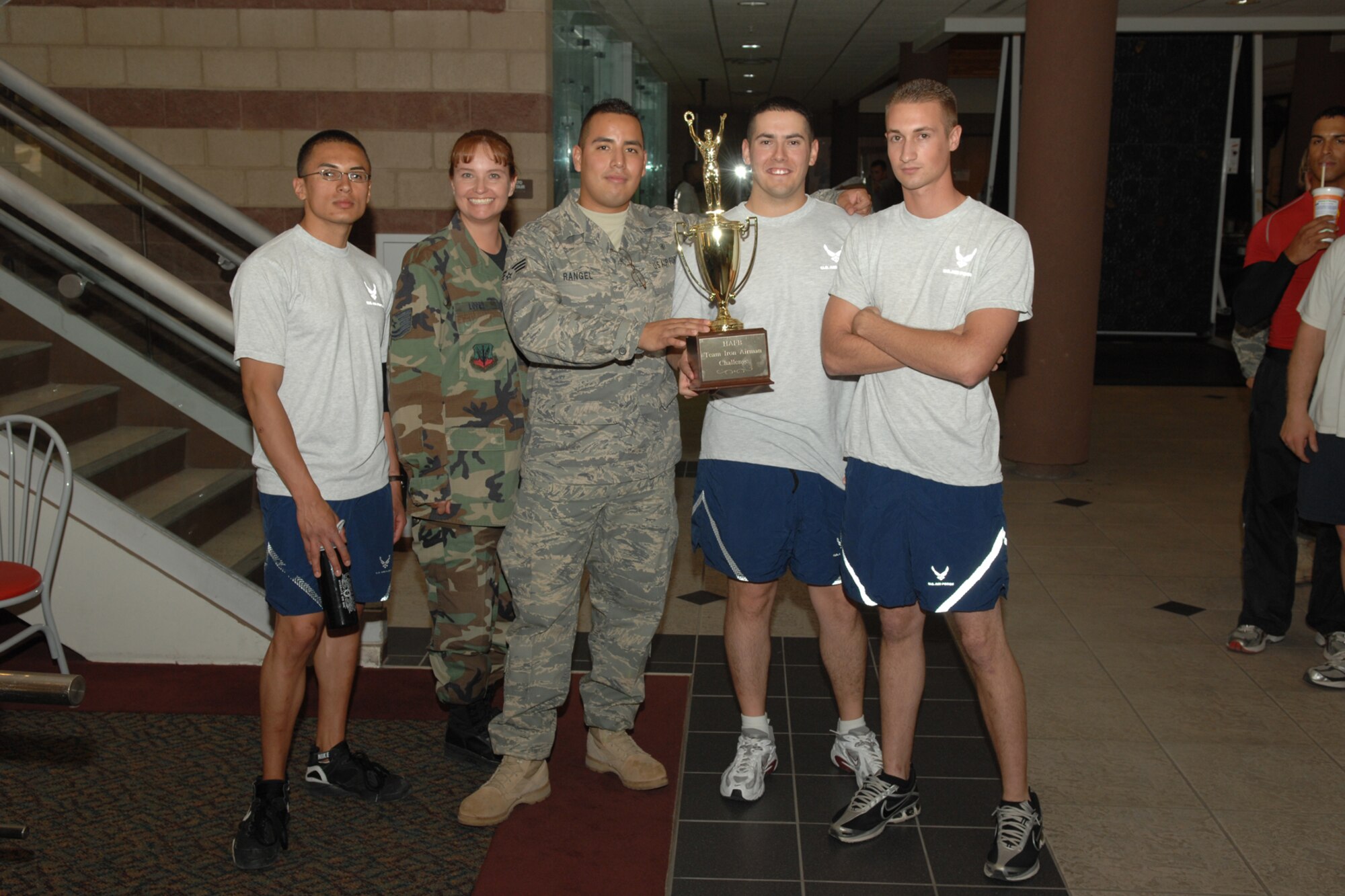 Representing the 49th Medical Group team one, from left to right, Airman 1st Class Emilio Rivas, Tech. Sgt. Lisa Lopez, Senior Airman Jacob Rangel, Senior Airman Anthony Hayner and Airman Jason Evans accept the 1st place trophy at the conclusion of the the first ever Team Iron Airman Challenge June 11 at the Fitness and Sports Center at Holloman Air Force Base, N.M. The team had a final score of 2221 points. Senior Airman Guadalupe Young, who also performed in the event, wasn't able to accept the trophy with the rest of her teammates. (U.S. Air Force photo/Airman 1st Class Jamal D. Sutter)